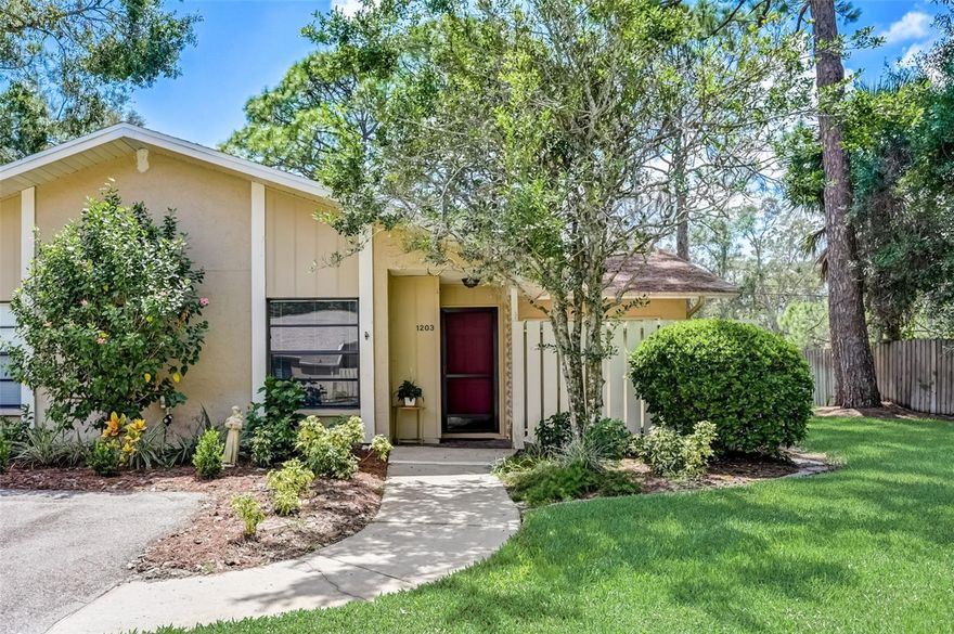 One or more photo(s) has been virtually staged. Live in paradise in this well-maintained villa located in an OVER 55 COMMUNITY. A peaceful quiet lifestyle awaits in this end unit opening to a very private yard area. Entering the home, a vaulted ceiling and updated luxury plank flooring await you. An open plan concept throughout the two livings area makes it perfect for entertaining friends and family. The family room has sliders that open to a large patio which gives you additional space. Sliding glass doors bring plenty of light for reading, art or other hobbies. Entertaining is easy with this kitchen featuring tons of cabinet and counter space open to the dining area and family room. Off the family room is a large lanai where you can sit back, relax and enjoy your favorite beverage while taking in the tranquil view of green space and mature trees. Escape to the large master bedroom featuring sliding glass doors that are accessible to the lanai, a large walk-in closet. The en-suite bath includes a walk-in shower and double vanity. The split bedroom accesses a separate guest bath. New washer and dryer are available in the home. Additional outdoor storage is available in the assigned covered parking space. This listing is OPTIONALLY FURNISHED WITH EQUIPED KITCHEN. The community features a canopy of mature oaks, a clubhouse where you can socialize with your neighbors in the screened in pool, play shuffleboard, exercise, relax in the library or reserve the big room with kitchen for parties. Find easy access to UTC Mall, Benderson Park, Sarasota’s cultural downtown, I-75, area medical services and the number one beach Siesta Key.