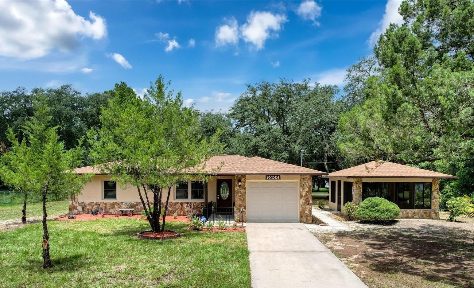 Embrace Florida living on this expansive 0.58-acre property, featuring three separate structures on the property. A spacious 2-bed, 2-bath home with 1,206 SF of comfortable living space. Highlights include a 15×18 screened stucco patio with electricity—perfect for relaxing or entertaining—and a versatile 16×22 detached stucco garage/workshop with built-in storage (adding another 600+ SF of space under combined roofs).
Inside, discover brand-new luxury vinyl flooring throughout, a fully upgraded kitchen with soft-close cabinetry and brand new fingerprint resistant stainless steel appliances, and brand new roofs on all three structures (July 2025) for worry-free ownership. Newer upgraded windows, well pump and installed ADT security system for optional monitoring and panic alerts.
The oversized lot offers abundant outdoor flexibility—garden, pool, RV or boat parking—and provides serene, rural-suburban privacy. Just minutes from the Homosassa wildlife park Springs, 3 Sister Springs, and Crystal River, boat ramps, scalloping and fishing hotspots, plus family-friendly parks, nature, and manatee tours. Located conveniently close to grocery, dining, near US-19 and Veterans expressway for regional access.
This meticulously updated gem blends turnkey ease with endless potential—come see why it stands out in Citrus County!