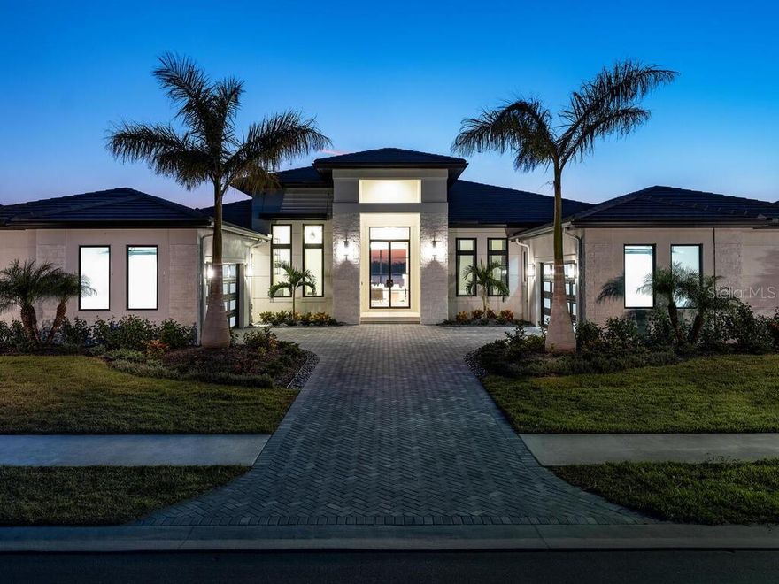 2025 Parade of Homes Winner! Custom Home Category and Best Residential Homes Finalist.  Model Home List Price: $4,268,000 (Model Home Net of a Leaseback) plus $330,000 (Furniture Package) equals $4,598,000.    Anchor Builders Martinique II  fully furnished Model Home at Wild Blue at Waterside is now available to purchase with a leaseback.  

The grand approach to this one-of-kind Transitional Model Home is highlighted by towering columns finished in Artic Hewn stonework and a horizontal louver shutter.  A wide paver driveway accented with Royal Palm trees and artistic landscaping provides easy ingress and egress to the oversized 4 car garages.  The extra wide Wild Blue 100' Lapis homesite provided custom home builder Roy Dupuis and their celebrated Residential Designer an exceptional opportunity to create a home that truly maximizes this homesite's spectacular big water and Sunset Views.   The front of the home faces a private preserve.
The moment you step from the seashell paver Grand Entry through the custom iron 10ft high doors, your immediate sense of arrival is that of a calming, welcoming and inviting feel of sanctuary.

 Your attention is immediately captivated by the uninterrupted sightline from the Foyer where you will welcome your guests to the spectacular lake view that elevates the tranquil and welcoming feel.
The Grand Room features vaulted ceilings with stained wood beams and stained wood archways, connected with wide galleries which invite you to each space with a beautiful blend of elegant, but soothing colors and textures.  This comfort and warmth transcend throughout the Owner's Suite, Fitness Room, Study, three ensuite Guest Bedrooms, Powder Bath, and generously appointed Outdoor Living-Dining-Pool Area that blend seamlessly with the indoor spaces.

The Wild Blue at Waterside Clubhouse will provide residents fine and casual dining, social events and a well-appointed fitness center, classes, personal training, golf simulator, movie theatre and more.  The shared Midway Sports Center will include 13 acres for neighbors to explore, play and connect.  Miles of lakeside and preserve walking paths and trails, 6 tennis courts, 8 pickleball courts, sports pro shop, kayak launch, playground and of course, 2 dog parks for our fury friends ... All created for your next chapter nature-centric, active lifestyle!

The List Price INCLUDES all Furnishings, Artwork, and accessories  which total $330,000.   Interior Design and Furnishings by Riley Interior Design.   The Sale will be subject to a Builder Leaseback.  List Price is Net of a Leaseback.