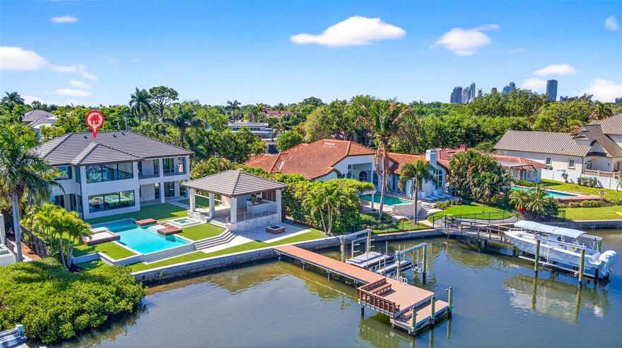 A striking expression of contemporary design and resort style living can be your own private oasis. A truly exceptional waterfront residence that has undergone two major renovations. Completely rebuilt in 2018 by Bright Bay Construction and further enhanced with a full first-floor renovation in 2026 with design assistance by Michael Masty and Haven Design. Over 5,300 square feet of Clean architectural lines, curated finishes, and seamless indoor-outdoor flow create a sophisticated yet relaxed residence designed for both everyday living and elevated entertaining. Ideally positioned on a quiet cul-de-sac in the coveted Coffee Pot Riviera of Snell Isle. This home is walking distance to the private Vinoy Golf Course and vibrant downtown St. Petersburg. The floor plan was thoughtfully designed to balance function and elegance. Featuring four bedrooms, a dedicated office, media room, and four full and two half well-appointed baths. The primary suite is a true retreat, showcasing expansive water views and a serene, spa-like ambiance, complete with a showstopping closet sure to impress any fashion enthusiast.
At the heart of the home is a stunning designer kitchen, appointed with high-end finishes, top-of-the-line appliances, a custom-built-in dining table.  Artfully designed glass-enclosed wine cellar serves as a striking focal point. The living area is anchored by a sleek linear fireplace, creating a warm yet modern centerpiece. The home office features elegant cove ceilings, offering a refined and inspiring workspace. The media room is complete with a convenient half bath, providing the perfect setting for movie nights or game-day gatherings. Step outside to a true resort-style experience. A covered outdoor kitchen and full pool bath complement the beautifully designed pool area, featuring cabana-style living with daybeds—ideal for relaxing or hosting guests. Lush turf and professionally curated landscaping enhance the property, creating a low-maintenance yet vibrant Florida oasis. Large new dock with 2 new lifts, one ready for your boat, the other with decking to make launching your paddleboards or kayaks a breeze.  The backyard will be your tranquil retreat where you can enjoy daily sightings of manatees and dolphins. For added peace of mind and long-term protection, the home is equipped with installed water dams, preserving the integrity of this exceptional property. The home also features a whole-home generator. Blending impeccable design, luxurious amenities, and an unbeatable waterfront lifestyle, this residence represents a rare offering in one of St. Petersburg’s most desirable neighborhoods.