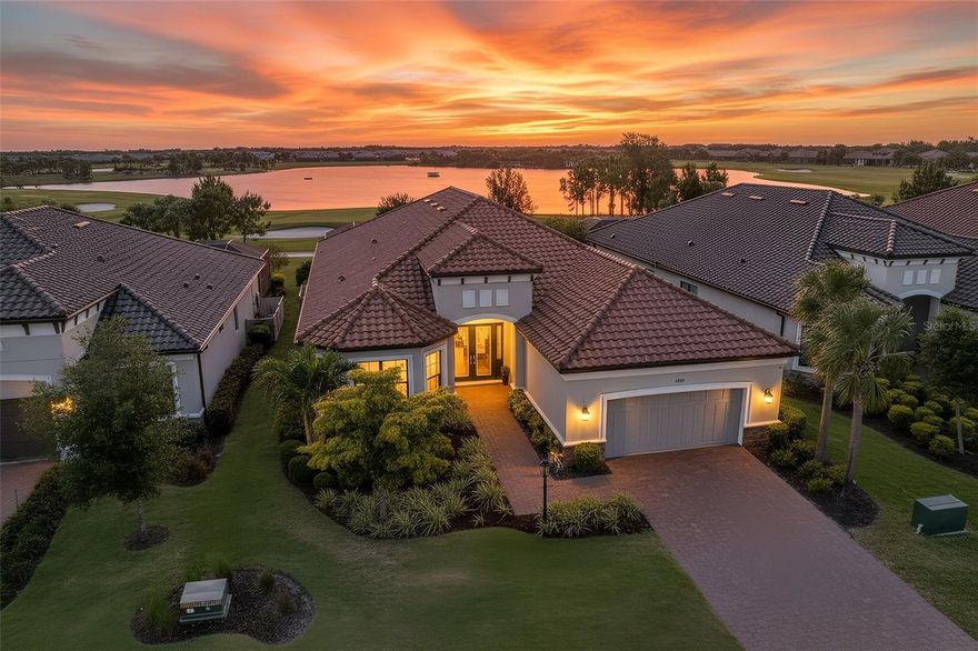 Experience elevated, resort-style living with full golf membership included in this exceptional Pallazio residence, located in the highly sought-after Esplanade at Azario within Lakewood Ranch. This GOLF-DEEDED home offers the rare opportunity to step directly into a luxury lifestyle centered around championship golf, world-class amenities, and effortless elegance.
Spanning 3101 square feet, this thoughtfully designed Pallazio floorplan by Taylor Morrison captures stunning POOLSIDE SUNSETS across a distant water view. Featuring three (3) bedrooms, a private study, and three (3) full baths, and an extended tandem two-car garage.
A grand double glass door entry welcomes you into a light-filled interior, where soaring tray ceilings, 8-foot doors, crown molding, and refined finishes create a sophisticated, inviting atmosphere.
Designed with privacy and functionality in mind, two guest suites—each with access to their own bathroom—are positioned at the front of the home, while the double-door study offers flexible space ideal for a home office, media room, or additional guest accommodations.
At the heart of the home, the open-concept great room seamlessly connects to the dining area and a beautifully appointed gourmet kitchen. Anchored by an oversized island, the kitchen showcases Cambria quartz countertops, soft-close cabinetry, a beverage center with glass-front accents, a spacious pantry, and a reverse osmosis water filtration system—perfect for everyday living and upscale entertaining.
The owner’s suite is thoughtfully tucked away at the rear of the home to capture tranquil golf course water and sunset views through an elegant bay window. A tray ceiling adds architectural interest, while the expansive walk-in closet and spa-inspired bath—w/ dual vanities, a soaking tub, and separate shower—offer a true sense of luxury.
Pocketing IMPACT sliders invite you outdoors, where the home transforms into a private resort.
The custom-designed lanai is a showpiece, featuring a fully equipped outdoor kitchen with granite counters, an Artizan gas grill, Perlick kegerator and beverage refrigerator, and Scotsman ice maker. Overlooking a stunning heated saltwater pool and spa, complete with a swim-up bar, the outdoor space is designed for unforgettable entertaining and relaxed evenings alike. Enjoy a daily backdrop of rolling fairways, the lake, and breathtaking Southwest Florida sunsets.
Living in Esplanade at Azario means embracing a lifestyle that rivals a five-star resort.
This stunning home is a short walk from the Azario amenity campus where residents enjoy access to an 18-hole championship golf course, Driving Range, Pro Shop, and Bunker Bar, along with a full suite of luxury amenities including a resort-style pool with Bahama Bar, a state-of-the-art fitness center, spa services, culinary center with teaching kitchen and Barrelhouse restaurant, tennis & pickleball courts, dog park, walking trails, and a vibrant social calendar curated by a full-time activities director.
Lakewood Ranch – the #1 multi-generational master planned community – This location offers convenient access to daily needs, as well as shopping & dining at Waterside Place, Lakewood Ranch Main Street, and The Mall at UTC. A short ride away is Sarasota-Bradenton International and Tampa International Airport, and the world-renowned Gulf Coast beaches.
More than a home—it’s a statement of lifestyle, where luxury, leisure, and championship golf blend seamlessly.