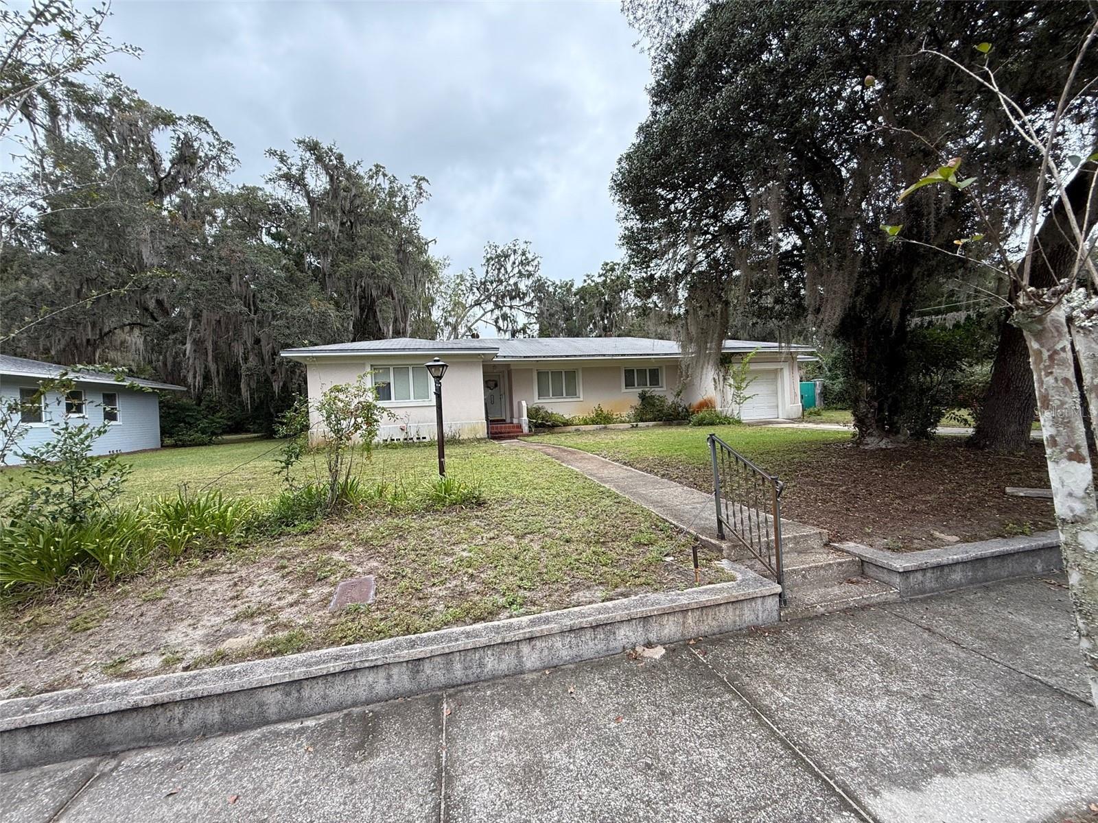 An amazing find in Florida Park! The main home is three bedrooms with two baths, a screened enclosed pool, and it's on a .77 acre lot. At the rear of the property is an additional structure which is two stories. Used previously as an office up top and storage on the bottom it also has a pull through one car garage with doors on either side. In addition to the main home, there is a contiguous .44 acre parcel that is being sold with it. The possibilities are endless for this property! ADU? In-law home? Art studio? Home office? You need to bring your imagination to this property. The main home is ready to move in, and could use updating but is livable,  the rear structure would need some finishes.