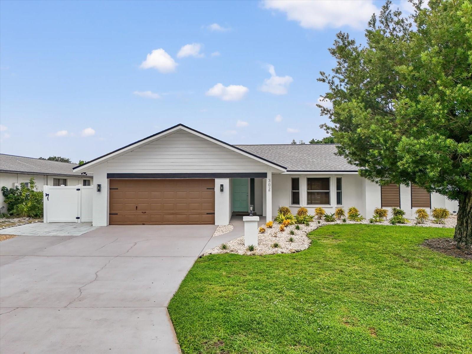 This beautifully updated pool home offers the perfect blend of comfort and peace of mind with hurricane impact windows, 200-amp electric service (2023), and a tankless water heater (2020). The home was freshly painted outside and includes a car charging station (2023)—a modern convenience for today’s lifestyle.
Inside, the inviting open floor plan features high ceilings, built-ins, and a cozy wood-burning fireplace in the living room. The chef’s kitchen is a showstopper with a massive island with bar seating, granite countertops, stainless steel appliances, a Frigidaire Professional double-door refrigerator, abundant cabinetry, under-sink water filtration, and a convenient pass-through window to the lanai.
The split-bedroom design provides privacy for the primary suite, complete with sliding doors to the pool concealed with a barn door, a large walk-in closet plus linen closet, and a spa-style ensuite featuring a granite vanity and walk-in shower. Across the home, two guest bedrooms—each with a walk-in closet—share a bathroom with granite countertops and a tub/shower combo, all tucked behind a pocket door for added privacy.
A functional laundry room with washer/dryer, storage cabinetry, utility sink, and a pocket door to keep it out of view adds everyday convenience. The spacious two-car garage offers extra storage space.
Step outside to your backyard oasis with a heated saltwater pool and recent upgrades, including a Hayward pool vacuum (2024), new salt cell (2025), LED multi-colored pool lights (2024), and a new pump/motor (2025). Enjoy an expansive covered lanai with hot tub, outdoor shower, firepit, and grilling station with electric and lighting. New landscaping and artificial turf complete the low-maintenance outdoor retreat.
With a low HOA of just $230 per year, excellent rental and Airbnb potential, and a prime location only 9 miles from Manatee Public Beach, this NW Bradenton gem checks every box.