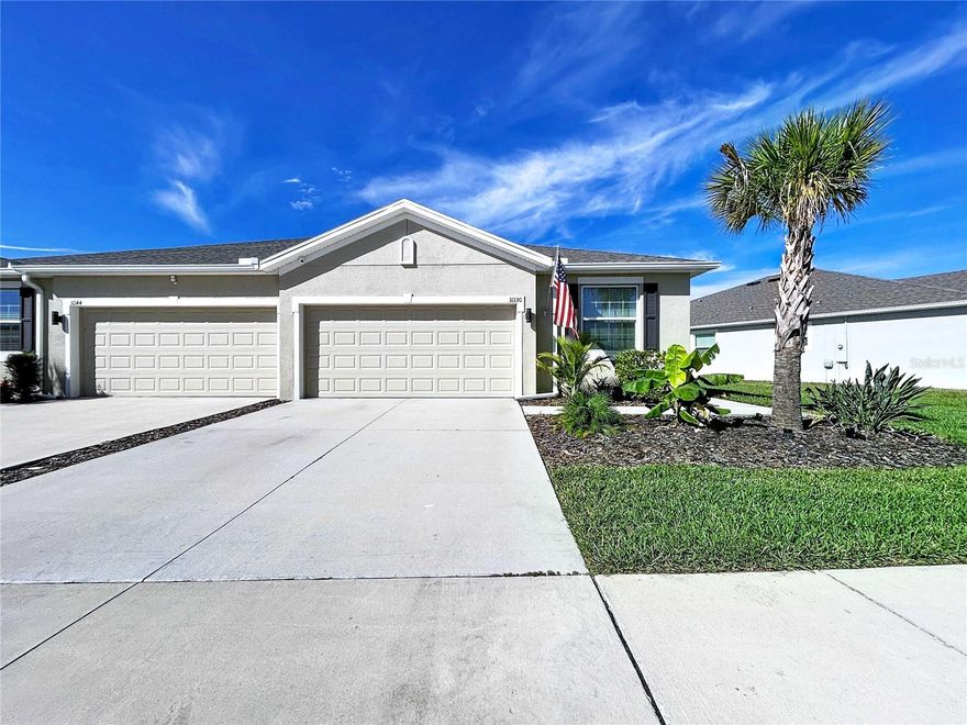 Introducing a villa like no other in the Mirada Lagoon community. Completed in 2023 and upgraded with over $50,000 in post-construction enhancements, this home blends modern finishes, a pond-view homesite, and low-maintenance living in one of Pasco County’s most active growth corridors.

The interior features luxury vinyl plank and tile flooring throughout, with no carpet anywhere, and a custom feature wall with a built-in electric fireplace that anchors the great room. The kitchen includes staggered 36" cabinets with crown, granite counters, stainless steel appliances, a tile backsplash, and an open layout transitioning toward the expanded outdoor living space.

Both bathrooms have been upgraded with floor-to-ceiling tile, and the primary walk-in shower now features a pebble-mosaic spa-style floor. The primary suite also includes a professionally installed closet system for optimized storage. Mechanical and functional upgrades continue with a whole-home water softener, smart-home system, and an epoxied garage floor, enhancing the attached two-car garage.

Outdoors, the home impresses with an extended and fully screened lanai overlooking the pond, plus a fenced backyard with privacy side panels. A premium glass entry door further elevates curb appeal. Concrete block construction, public utilities, and underground electric add long-term practicality.

Mirada delivers deed-restricted living, park space, and access to the region’s 15-acre MetroLagoon, all supported by convenient proximity to I-75, SR-52, Publix, and Wesley Chapel’s shopping corridors.