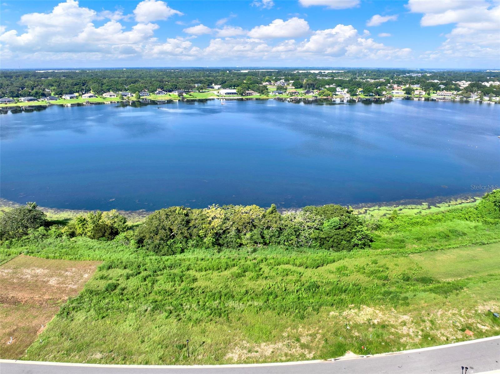 Build the home of your dreams on this exceptional lakefront lot offering direct shoreline on beautiful Lake Tennessee. Nestled within the
prestigious, gated community of Lake Juliana Estates, this cleared lot is ready for your vision—offering panoramic water views and access to a
serene 108-acre public lake ideal for boating, fishing, water skiing, and more. Residents of Lake Juliana Estates enjoy exclusive, resort-style
amenities including a clubhouse, fitness center, tennis and pickleball courts, and a private community boat ramp to Lake Juliana. Conveniently
located near I-4, this prime location provides easy access to both Orlando and Tampa. Don’t miss the chance to own a slice of lakefront paradise in one of Central Florida’s most desirable communities!