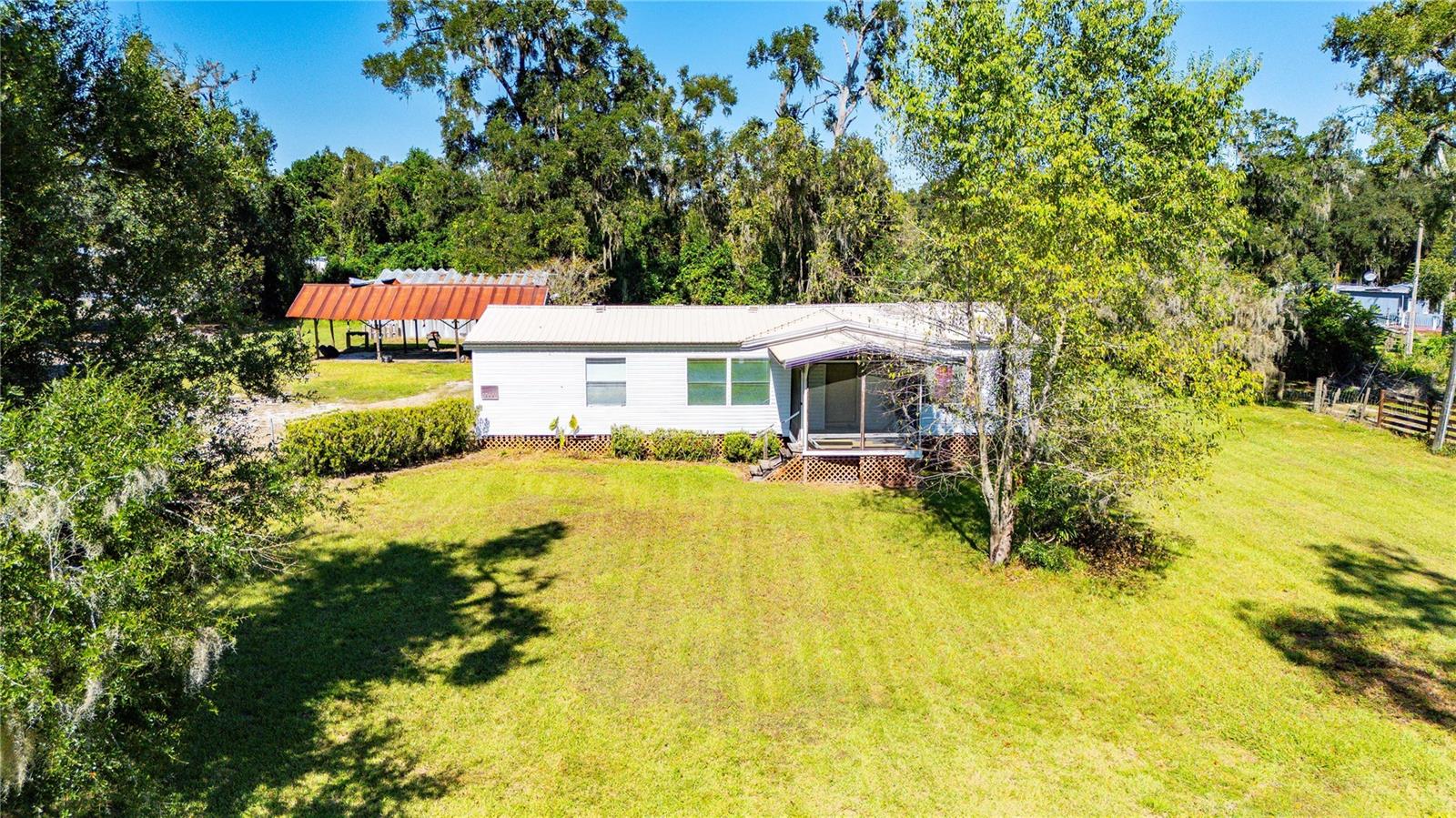 Escape the hustle and bustle and embrace peaceful country living in this beautifully maintained 3-bedroom, 2-bath mobile home nestled on a generous 2.5-acre parcel in charming Dade City. With room to roam, a versatile detached shop, and a comfortable interior, this property offers the perfect blend of privacy, functionality, and Florida charm.
As you arrive, you’ll be greeted by the serenity of wide-open space, mature trees, and the gentle sounds of nature. The home itself is thoughtfully laid out, featuring a spacious living area that flows seamlessly into the dining room and kitchen. Whether you're hosting family gatherings or enjoying a quiet evening in, the open-concept design makes everyday living feel effortless.
The kitchen is well-equipped with ample cabinetry and plenty of counter space for meal prep and entertaining. Each of the three bedrooms offers generous proportions, with the primary suite boasting its own private bath for added comfort and convenience. The second full bathroom is easily accessible for guests and family members alike.
Step outside and discover the true gem of this property: 2.5 acres of usable land, perfect for gardening, raising animals, or simply enjoying the outdoors. The detached shop adds incredible value, offering space for hobbies, storage, or a home-based business. Whether you're a craftsman, mechanic, or weekend tinkerer, this shop is ready to support your vision.
Located in the heart of Dade City, you're just minutes from local shops, restaurants, and schools, yet far enough to enjoy the peace and quiet of rural living. With easy access to major highways, commuting to Tampa, Wesley Chapel, or Brooksville is a breeze.
This property is ideal for those seeking space, freedom, and the opportunity to live life on their own terms. Whether you're starting a homestead, expanding your workshop dreams, or simply looking for a comfortable home with room to grow, this Dade City gem is ready to welcome you.