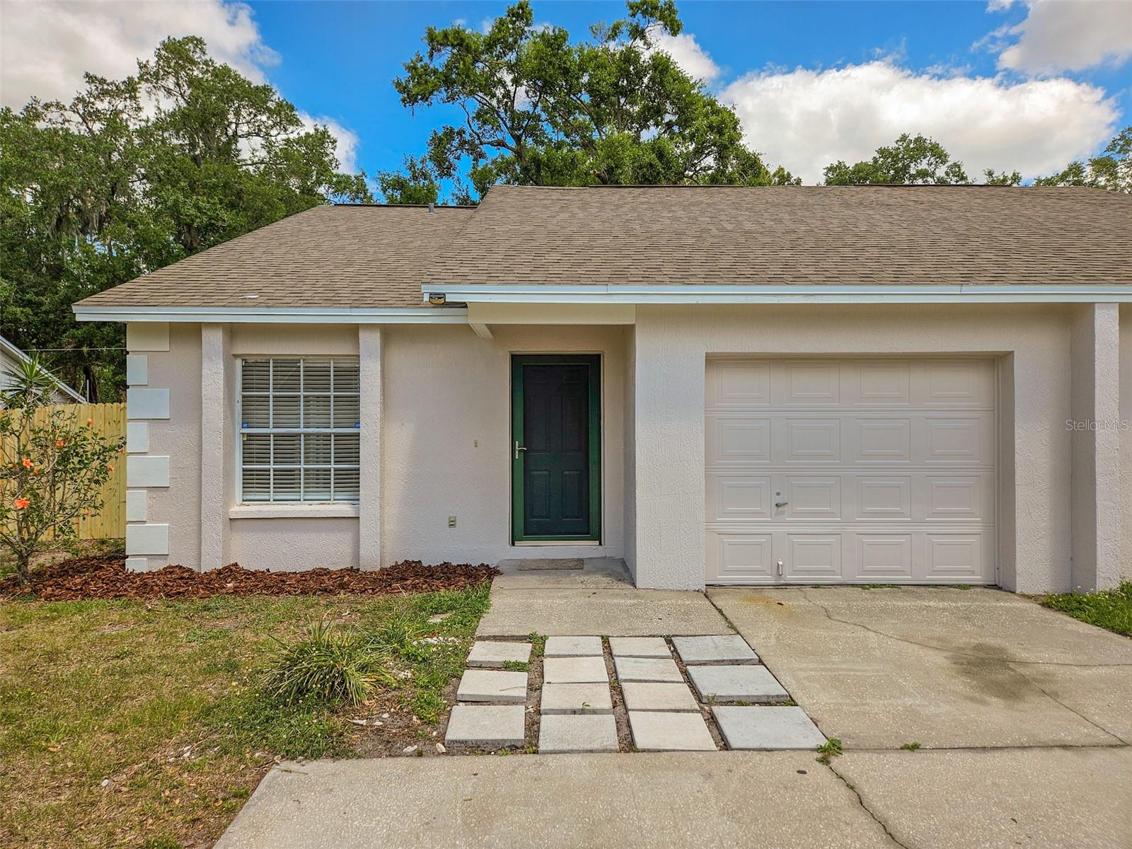 Spacious 3BR/2BA Half Duplex with Loft & Garage in South Lakeland! Welcome to this beautifully maintained half duplex located on a quiet street in desirable South Lakeland. This 3-bedroom, 2-bath home offers a bright, open floor plan with vaulted ceilings and abundant natural light throughout. The updated kitchen features sleek granite countertops and a stainless steel refrigerator, perfect for cooking and entertaining. Tile flooring runs through the main living areas, while the bedrooms and upstairs loft have brand-new carpeting for added comfort. The versatile loft space could be a 4th bedroom, home office or playroom. Step outside to enjoy a screened-in patio and a private, fully fenced backyard—perfect for relaxing or entertaining guests. Additional features include a 1-car garage and a prime location just minutes from Lakeland Linder Airport, shopping, dining, and easy access to the Polk Parkway. Upgrades in 2025 include a new A/C system, all new carpet, and fresh exterior paint.