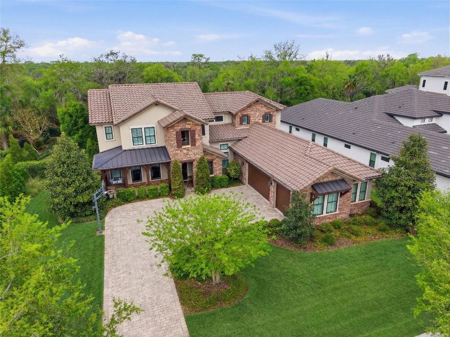 Welcome to gated FishHawk Preserve in FishHawk Ranch — where timeless Tuscan elegance meets resort-style living on a private conservation homesite. This stunning two-story home offers extraordinary natural light, soaring two-story ceilings in the great room with custom wood ceiling, and rich Shaw hardwood floors throughout the entire home. Deep wood window casings, framed doorways, 12” raised baseboards, crown molding, plantation shutters, and a hand-painted wood stair railing create a level of craftsmanship rarely found. The gourmet kitchen is truly the heart of the home, featuring two oversized islands, beveled-edge granite countertops, abundant cabinetry, top of the line granite & viatera quartz on both kitchen islands and a custom butler’s pantry with wine refrigerator. The adjacent great room is perfect for entertaining. The owner’s suite is a private retreat with tray ceiling and crown molding, spacious walk-in closet, double vanities, quartz countertops, garden tub, large walk-in shower, and linen closet. A custom 8x8 rear bump-out with vaulted ceiling was added during construction and is currently used as an office overlooking the spectacular pool and conservation. All secondary full baths have quartz countertops and the half bath has high level granite countertops. The home is prewired for surround sound. 
Step outside to your private resort oasis featuring:
• Infinity-edge pool with Pebble Tec finish
• Travertine pavers
• Sun shelf with bubbler
• Stack stone waterfall
• Oversized attached spa
• Multiple color-changing lights
• Pergola
• Landscape lighting
• Gas pool heater (2024)
• Separate pumps for pool and spa
The fully fenced backyard offers privacy and gate access on both sides.
Additional upgrades include:
• Tile roof and stacked stone exterior accents
• Pavered driveway and side-entry garage
• Two separate AC systems (upstairs & downstairs)
• Water softener and whole-home filtration
• Whole-home gas plumbing
• Gutters
• Pull-down attic with floored storage
• Fully air-conditioned garage flex room with cabinets and granite counter
Energy-efficient features include double pane Low-E windows, radiant barrier, R-30 ceiling insulation, 15 SEER HVAC, programmable thermostats, and more. This home blends luxury, efficiency, privacy, and functionality in one of FishHawk’s most sought-after gated communities. Call today for your private viewing.