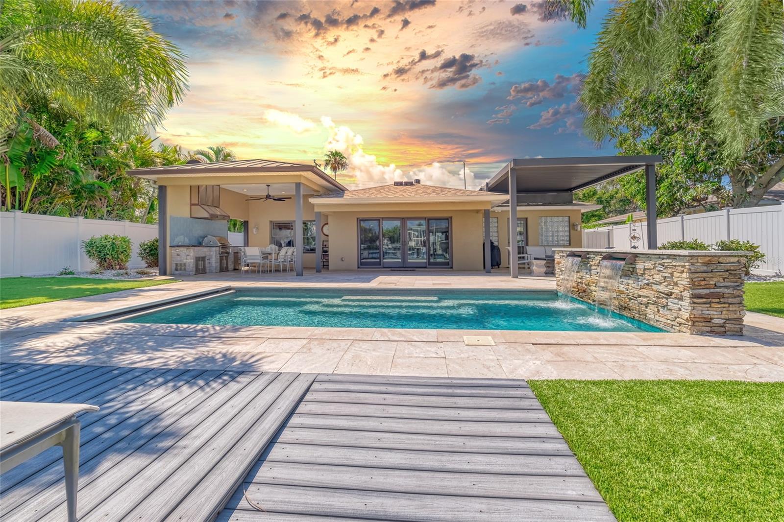 When I say that this is the ultimate full time vacation paradise, it isn’t an overstatement! From the moment you enter this stunning 3-bedroom 2 bath waterfront pool home you will be taken in by the fine materials used to complete this masterpiece and the spectacular views of the intracoastal waterway from nearly every room. This home was gutted and reimagined beginning in 2012 and over the years a long list of detailed upgrades have been added beginning with all the basics… new electric, drywall, Maplewood Anderson impact windows, doors, and plumbing and new roof in 2022. The owner did not skimp on all of the cosmetic touches either! The floors are covered in high polished marble and imported Italian oak! From the entryway the home flows into the two amply sized living spaces with double sided gas fireplace and right into the large eat in kitchen. The kitchen is outfitted for the most discerning home cook with a large pantry, upgraded stainless appliances and the most beautiful 1 of 1 custom leatherized granite counters. The primary bedroom offers 2 walk-in closets and an en-suite bathroom with soaker tub and walk in shower that connects out to the pool! There are two guest bedrooms as well that share a luxuriously remodeled bath. The current owners have set up the 3rd bedroom as a perfect office to work from home! If you love to entertain or just want a spot that feels like you're on vacation 24/7 this backyard will blow you away. The pool is the perfect size and includes a custom copper water feature, a cover and it is heated and chilled! The outdoor dining area is equipped with a lynx grill and custom range hood. The lounge area to the west is covered by an electric awning giving you the ability to open or close it to take in the sun! The landscaping is lush and well maintained and the lawn is turf to save on water. The dock is built out of a composite material for low maintenance and there is water and electric run out alongside the 10,000 pound remote controlled lift. The sides of the property have also been thought about so you can take advantage of all that Florida beach life has to offer too. Here you will find racks for canoes and paddle boards, pool storage and an outdoor shower. This is also the location of the 20 KW whole home generator. Hopefully the times when it is needed are rare but imagine the piece of mind that comes along with knowing it is there in times of crisis. The prime location of this property puts you just within minutes of private resident access to the white sandy beaches of Redington! You are near plenty of shopping, activities and all that our beautiful area has to offer! Only 30-45 minutes to TPA and downtown St Pete. This home truly has it all. All of the hard work has been done and now you can move on in and start your endless summer vacation! Whether you are looking for a primary residence or a vacation home, this spectacular property is the ONE!