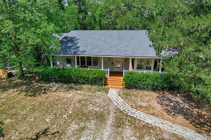 Five acres of privacy, a brand new roof, and a wraparound porch that makes it impossible to leave. This four-bedroom, two-and-a-half bath home is the kind of property that doesn't come along often.
The land sets the tone immediately. Whether you're envisioning a flourishing garden, a small flock of chickens, or simply open space to call your own, the possibilities here are genuine. The wraparound porch, screened on one end, gives you a front-row seat to all of it, morning coffee in hand or evening breeze rolling through.
Inside, the layout is generous and flexible with 10 ft ceilings throughout the home. Large living areas handle gatherings with ease, a dedicated office keeps work separate from life, and the game room is the kind of bonus space that becomes the heart of the home. The kitchen anchors everything with solid cabinet and counter space, stainless steel appliances, and a bay window that frames the kind of view you moved to the country for.
The oversized utility room just off the kitchen offers storage, a laundry sink, and extra refrigerator space. It's a practical detail that owners of larger homes genuinely appreciate. The primary suite fits a king bed comfortably and still has room to breathe, with dual sinks, a walk-in shower, and a soaker tub in the bath.
This is a home designed for people who want space, freedom, and a little quiet. If that's you, it's time to come see it.