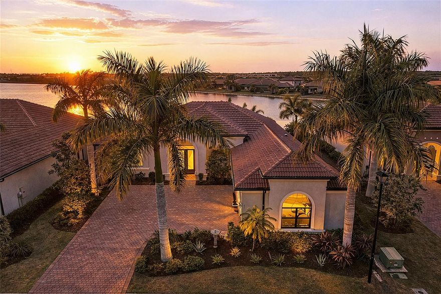 Experience the allure of breathtaking sunsets and shimmering big water views of Lake Awesome in this dream luxury residence complete with an infinity edge pool and expansive outdoor living area. Nestled on nearly a quarter-acre lot with no homes obstructing your view from the front, this exquisite San Marino floor plan is a rare find, perfectly designed for today’s discerning buyers. This thoughtfully designed open floor plan showcases three generous bedrooms, three modern bathrooms, an inviting formal dining room, a spacious bonus room, and a roomy three-car garage. You’ll be impressed by contemporary luxury features such as a 250-gallon underground propane tank fueling a gass cooktop in the kitchen, PGT Windguard hurricane-resistant windows and doors, sophisticated wide wood-look porcelain tile flooring in the main living spaces, and brand-new plush carpeting in the bedrooms. The coffered ceiling and extensive crown molding add an extra touch of elegance to the welcoming ambiance. The gourmet kitchen is a culinary masterpiece, equipped with upgraded two-tone cabinets featuring soft-close mechanisms, high-end Electrolux stainless-steel built-in appliances, a gas cooktop, and a sleek stainless-steel vent hood, all enhanced by a chic designer backsplash. The primary suite, conveniently located on the left side of the home, serves as a peaceful retreat, complete with a luxurious en-suite bathroom. Enjoy a serene soaking tub, a spacious walk-in shower, dual sinks, and a linen closet. Recent enhancements include a stunning custom closet by California Closets and new plush carpeting. Awaken each morning to invigorating views of the pool and the enchanting Lake Awesome beyond. Two additional bedrooms are ideally positioned on the opposite side of the home, each boasting ample walk-in closets for comfort and privacy for family and guests. At the rear of the home, the expansive bonus room welcomes you with a picturesque view of Lake Awesome, perfect for whatever activity you desire. No Florida lifestyle is complete without a breathtaking outdoor living area, and this home offers a stunning infinity edge heated pool and spa, featuring elegant upgraded glass tiles, along with an expansive lanai that is pre-plumbed for an outdoor kitchen, featuring a gas hookup for grilling, and offering abundant space for delightful al fresco dining. Live an active and vibrant lifestyle year-round in Toscana Isles, a gated community that offers resort-style living with maintenance-free convenience. Enjoy kayaking, canoeing, and fishing directly from your backyard, surrounded by over 200 acres of interconnected lakes. The impressive 8,000-square-foot clubhouse features a state-of-the-art fitness center, a ballroom, billiard room with big-screen TV, and much more to enrich your community experience. Toscana Isles is perfectly positioned just six miles from the stunning Nokomis Beach, a quick 10-minute drive away, and near the picturesque Legacy Bike Trail, plus the bustling downtown areas of Venice and Sarasota. Experience rich cultural offerings, fantastic shopping, and exquisite dining, all at your fingertips. Additionally, the newly opened nearby Sarasota Memorial Hospital Venice campus adds an extra layer of convenience. Seize this remarkable opportunity! Contact us today to schedule your private showing and take the first stride toward making this spectacular home your own!