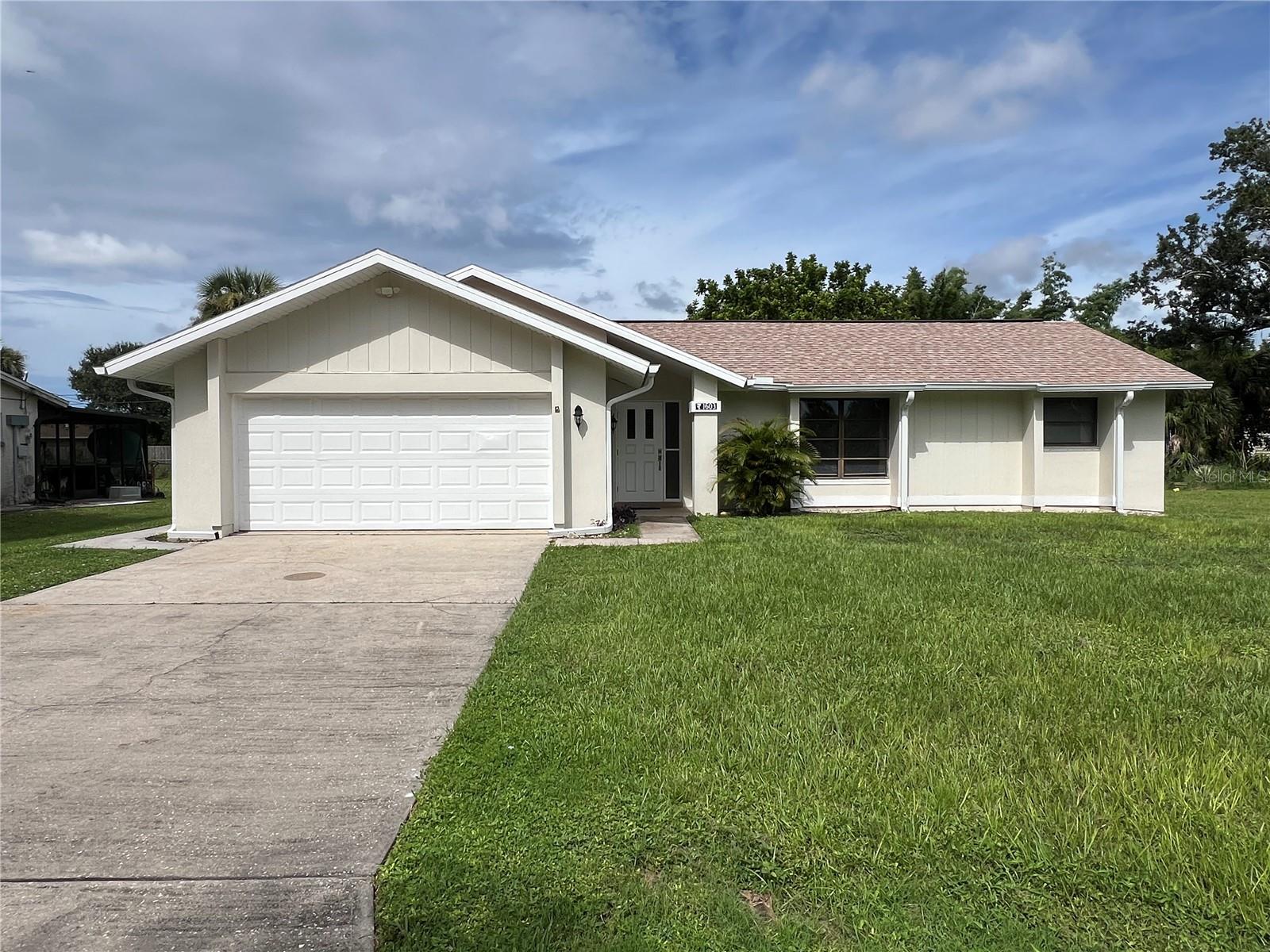 Cute freshly painted 3 bedroom, 2 bathroom, 2 car garage home NOT in a Flood Zone! NEW septic and drain field, 2022 shingle roof, 2017 flat roof, 2021 water heater, NEW paint inside and out, enclosed Florida room PLUS covered screen lanai! This home features tile throughout, a split bedroom floor plan and the 3rd naturally bright bedroom with bay windows is perfect for an office or craft room. Living room is open to the formal dining room and there is a breakfast nook near the kitchen to enjoy your morning coffee or tea. The primary bedroom features a walk-in closet plus linen closet for added storage. Home has several closets throughout which is a nice bonus. The home was built by a builder so there is a light switch in the garage that turns off power to the garage door for added security while you are away. The home also has hurricane shutters that the owner installed for all of the windows. Conveniently located near shopping, dining, parks, entertainment, schools, and hospitals!