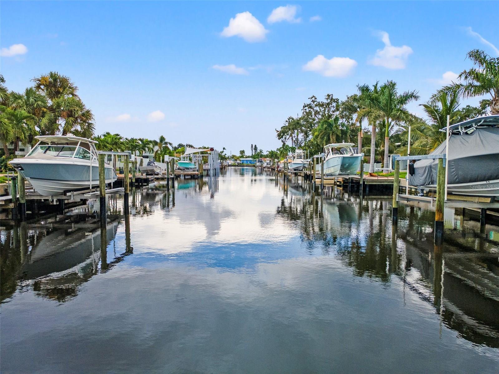 Turn-key luxury waterfront living in Patrician Point! This two-story St. Petersburg home offers the ultimate Florida lifestyle with a private dock and quick access to the bay. The chef’s kitchen features custom cabinetry, granite countertops, a designer backsplash, and premium appliances including a Thor gas range. Abundant natural light fills the living spaces, creating a bright and inviting atmosphere throughout the home. The spacious living areas showcase porcelain tile flooring, two fireplaces, and a full wet bar with a pass-through to the kitchen, perfect for entertaining. A versatile formal dining room can double as a home office, while a full bath completes the main level.
Upstairs, you’ll find the 2nd bathroom, 2 generously sized bedrooms with engineered hardwood flooring, as well as a primary suite complete with a custom walk-in closet and en-suite bath. Outside, enjoy waterfront living at its best with room to boat, fish, and entertain. Just minutes from Downtown St. Pete, beaches, dining, and museums, this home is a rare blend of elegance, convenience, and lifestyle.