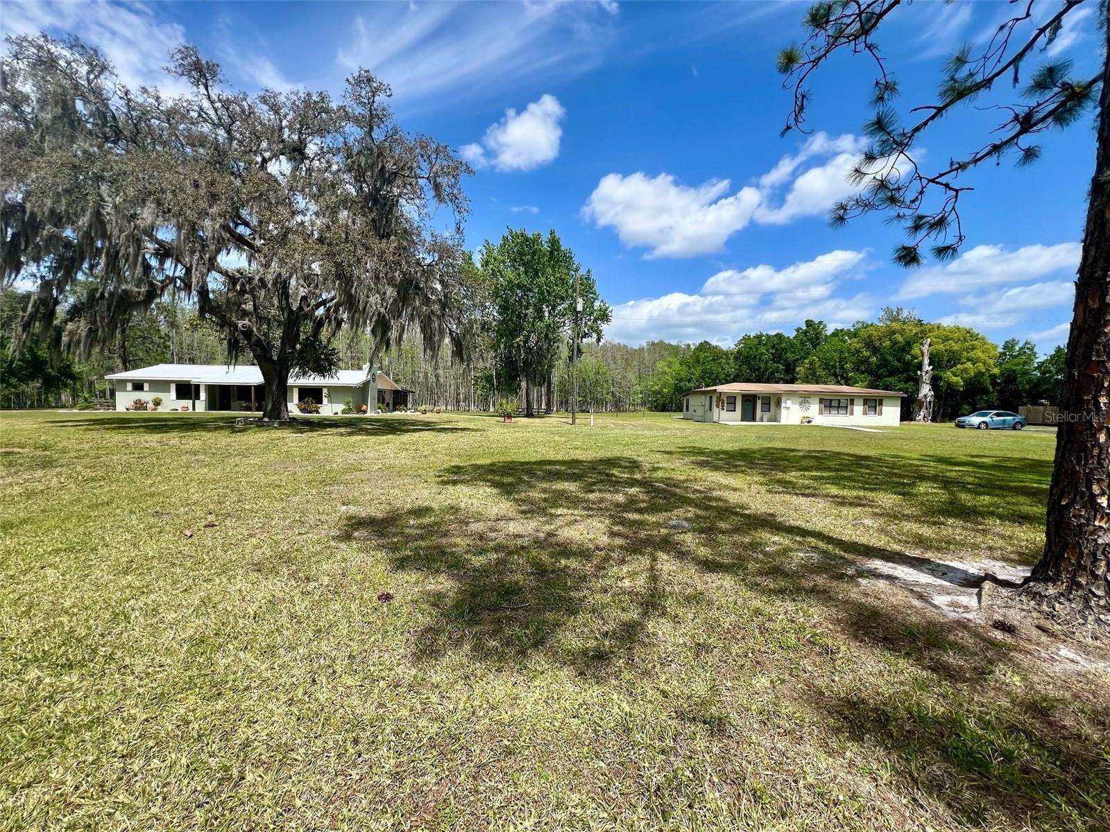 WOW, TWO HOMES ON 10.5 MOL ACRES THIS WON'T LAST LONG!
LOOKING FOR A PLACE FOR A FAMILY COMPOUND
***10.5 MOL ACRES | 2 BED | 2 BATH | 4-BAY PARKING /MAN CAVE, ***PLUS ADDITIONAL 2 BEDROOM 1 BATH BLOCK HOME *** | Zoned 1 Home an Acre | Fenced for Cattle & Horses***
Welcome to your own slice of peaceful Florida countryside! This 10.5 acre property is a rare gem located within the city limits of Groveland, zoned 1 home an acre, offering future development potential or room for a family compound. (ADDITIONAL 3RD HOME IN A SEPARATE LISTING TB8331889)
The well-maintained 2-bedroom, 2-bath home features a spacious open floor plan, perfect for comfortable living or entertaining. Enjoy natural light, great flow between kitchen, dining, and living spaces, and peaceful views of your surrounding land.
The land is fully fenced and cross-fenced for cattle, making it ideal for anyone looking to start or continue an agricultural lifestyle. A standout feature is the large 4-bay barn, with a 1,600 sq ft enclosed man cave/workshop area and over 2,500 sq ft of undercover parking—perfect for vehicles, boats, equipment, or hobbies.
Tucked back from the main road, the home offers privacy with a long private drive—no drive-bys, please. You'll appreciate the combination of city water and a private septic tank, offering both convenience and independence.
This is a unique opportunity to enjoy country living with city convenience, just minutes from Groveland’s shops, restaurants, and main highways. Whether you want space to roam, raise animals, or explore investment potential, this property checks all the boxes.
iMPORTANT :call for more information! PLEASE READ REALTOR NOTES! 3RD HOME SEPERATE LISTING TB8331889
Please respect privacy—no drive-bys- APPOINTMENT ONLY SHOWINGS. Parcel Numbers : 1397740,3425898,1397731 , it is in the processes of being surveyed.