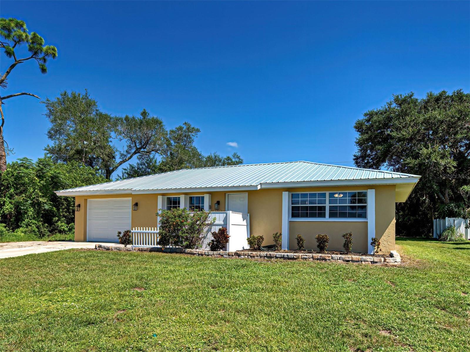 One or more photo(s) has been virtually staged. A Must See. This charming two bedroom, two bath home has a one car garage and nice lanai and is centrally located in the Heart of Port Charlotte. The home features tile floors throughout and an updated kitchen with granite counter tops, shaker style cabinets and new stainless steel appliances. The open concept makes this home feel much larger than it's square footage. There is an enormous laundry room with extra space for pantry storage. The primary bedroom has an en suite bathroom with a large walk in shower. The second bedroom has a separate bathroom across the hall which features a large walk in shower as well. Both bedroom closets are ready for you to "customize" to your own personal needs. The large lanai right off the kitchen provides even more living space for eating, entertaining or watching TV. Other upgrades include a metal roof in 2023, A/C in 2021, new lights/fans, painted inside & out 2025, City Water & Sewer and hurricane shutters. The large one car garage has a workbench and there is a 9x9 metal storage shed for tools and toys. Azalea Ave is off W Tarpon and just minutes to 41 and all the shopping, restaurants, groceries, banking and medical services available in Port Charlotte.