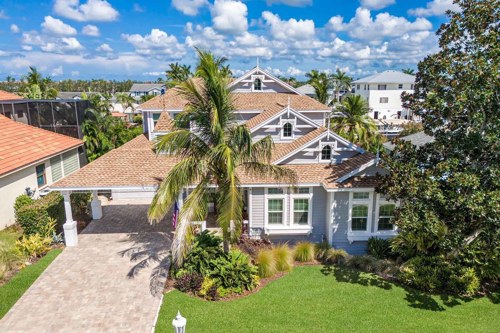 Stunning Waterfront Retreat in The Inlets!!! This 5 bedroom with office, 4.5 bathroom home offers over 4,300 SqFt of living space and is located on a SALTWATER CANAL with direct access to the Manatee River, Tampa Bay, and the Gulf!!! This stunning coastal residence truly embodies the best of Florida living. The former developer’s home, it showcases timeless Key West architecture, lush tropical landscaping, and thoughtful upgrades throughout. The approach sets the tone, with mature palms, manicured gardens, and a paver driveway leading to the home’s light hued exterior and charming architectural details. New roof, Hardy board siding, and striking curb appeal make this property both beautiful and enduring. Step inside to soaring ceilings, rich hardwood floors, and sun filled spaces framed by transom windows and plantation shutters. The great room is the heart of the home, featuring 20-foot ceilings, modern cable railed staircases, custom built ins, and a seamless flow into the designer kitchen. Recently updated, the kitchen boasts white cabinetry with gold hardware, a bold center island with gas cooktop, stainless steel appliances, walk in pantry, farmhouse sink, prep sink, designer lighting, and a custom tile accent wall—perfectly blending elegance with function. Just off the kitchen, a charming alcove with built-in desk provides the ideal spot for work or study. The first-floor owner’s suite offers a peaceful retreat with a spacious sitting/exercise area, his and her closets, and a spa inspired bath with dual marble vanities, soaking tub, walk-in shower, and private water closet. Additional main-level highlights include a formal dining room, front office, laundry with cabinetry and utility sink, pool bath, and a generous IN-LAW SUITE with private entrance. Upstairs, a versatile bonus loft connects three bedrooms and two bathrooms, while the finished third-floor flex space is perfect for an art studio, craft room, or kids’ hideaway. Outside, discover your private waterfront oasis! A heated, saltwater pool and spa anchor the spacious patio and covered lanai, designed for year-round relaxation and entertaining. String lights create evening ambiance, while lush landscaping ensures privacy. Just beyond, your private dock with 16,000-lb boat lift provides effortless access to boating, fishing, and waterfront adventures. Whether lounging poolside, hosting friends under the lanai, or setting out toward the open waters, this residence is designed to embrace the Florida waterfront lifestyle at its finest. DO NOT WAIT ON THIS AMAZING PROPERTY- TRULY THE BEST DEAL IN THE INLETS!!!