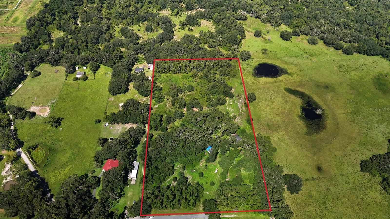 Discover your own slice of rural paradise on this tranquil 11-acre ranch retreat in a private, shaded setting, perfect for cattle or horses. This fully fenced property is thoughtfully equipped with two wells and one septic system, so you can focus on what matters—raising livestock, creating a stable, or simply relishing the serene, open air. Towering oak trees frame the landscape, their branches offering shade and quiet moments of reflection as the land hums with possibility. A spacious double-wide home stands at the center, solid in structure yet calling for your personal vision to bring it back to life, while a second home tucked beneath a carport awaits a full gut and renovation—an ideal blank canvas for creating additional living or working space. Whether you dream of morning rides across pasture, setting up barns and arenas, or simply savoring the peaceful stillness of country living, this property offers both the infrastructure and the promise of transformation. With its unique blend of natural beauty, practical features, and compelling potential, this ranch won't stay on the market long—schedule your private tour today and imagine the life you could build here.
