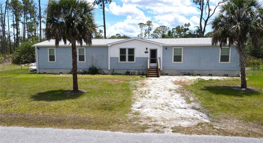 **PLEASE ENJOY THE 3D INTERACTIVE VIRTUAL TOUR ASSOCIATED WITH THIS LISTING – Experience modern country-style living in this spacious 4-bedroom, 2-bath modular home offering more than 2,000 square feet of beautifully designed living space. Built in 2024, this Palm Harbor Homes Lifestyle Series “Scottsdale” model combines comfort, style and functionality on over ½ acre of property. The gourmet kitchen is a standout feature, complete with abundant cabinetry, modern finishes and a large walk-in pantry. Just off of the kitchen, the laundry/mudroom provides convenient access to an outdoor sitting area, perfect for enjoying peaceful mornings or relaxing evenings. The oversized primary suite is truly a retreat, featuring a spacious walk-in closet and a luxurious en-suite bath with dual sinks, a separate soaking tub and a walk-in shower. The split-bedroom floor plan offers added privacy, with the additional three bedrooms located near the guest bathroom. Luxury vinyl flooring runs throughout the home for both durability and style. Situated on more than half an acre, this property provides plenty of room to add a carport, detached garage, pool or additional outdoor living space if desired. Conveniently located near the thriving area of North Port, you’ll enjoy easy access to spring training baseball, numerous parks, the scenic Myakka State Forest and a wide variety of shopping, dining and everyday conveniences nearby. Take the virtual tour using the provided link, then schedule your private showing to experience this one-of-a-kind home for yourself!