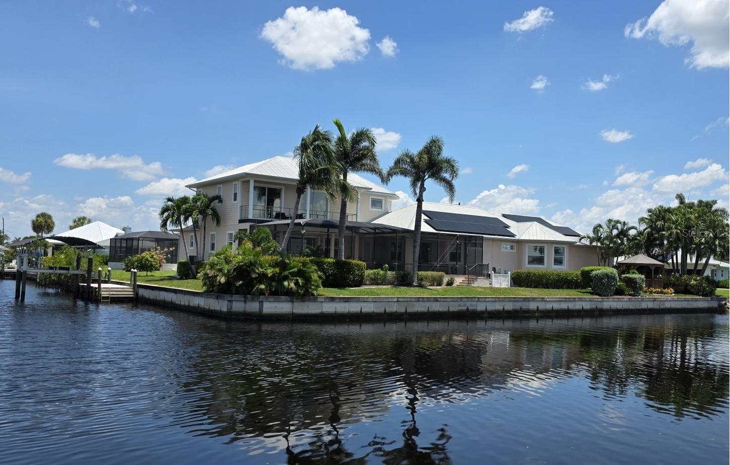 Welcome to Paradise!! Time to Start Living the Florida Lifestyle in this Luxurious 4 Bedroom, 3.5 Bath, 2 Car Garage Pool Home offering 247 feet of Sailboat Saltwater Frontage with short boat ride out to the Gulf waters....with over 4100 sf under air, you will be astonished how much room and privacy you have in this spectacular home.
You will fall in love with this Beautiful Florida Home as you walk through the etched glass double doors....into the foyer that flows into the Great room with amazing views of your private saltwater heated pool and stunning views of the waterway. The living room area features vaulted ceilings with a built-in entertainment center that includes the tv. The Kitchen is a chef's dream with a huge 2-tier breakfast bar, granite countertops, plenty of cabinets and countertop space and center island with wine rack for that extra touch.... The dinette area has three huge windows with exquisite views of the water...The formal dining room has tray ceiling with crown molding to give it that extra touch of class. The Primary bedroom is located on the main floor and is immaculate and huge, has two walk-in closets, large sitting area with sliding glass doors out to your private sparkling pool. Primary Bathroom is amazing with long vanity with dual sinks, garden tub, glass enclosed walk-in shower that is nicely tiled with 5 jets & handheld showerhead and separate toilet area. The second bedroom/office is also on the main floor and quite spacious with two closets. The second bathroom is on the main floor and features a nice vanity, glass enclosed walk-in shower, built-in shelves and door out to your lanai/pool area. The 3rd and 4th bedrooms are upstairs and have walk-in closets and both have sliding glass doors out to the adjoining balcony with new Nezan balcony railings with Spectacular Views of Your New Florida Lifestyle!! The third bathroom is just across from the two bedrooms upstairs... features long vanity with dual sinks, tub/shower with nice tile walls and linen closet.
The laundry room is nice size just off the kitchen and features washer, dryer, utility sink and kitchen pantry closet. Half bath is just off the kitchen and great room. Other Features of this Gorgeous Waterfront Home: Tile flooring throughout except the bedrooms and formal dining room have luxury vinyl flooring, Plantation shutters throughout including on all the sliding glass doors, high impact windows, 35 Solar Panels with electric bill under $50 a month, A/C 2019 & 2021, water heaters 2016 x 2 upstairs, metal roof screws replaced in 2023, Gazebo 2023, concrete curbing 2023, boat lift & cover 2023, composite dock w/electric, pool heater/pump 2023, Hot tub with cover 2022 and more..... ***One Year Home Protection Plan Included***
Relax out back by your sparkling pool or enjoy hanging out at your Gazebo with breathtaking views of the water.... plenty of room to entertain... Nearby shopping, restaurants, golfing, fishing, parks, beaches and more...... Great Price!!! Great Curb Appeal!!! Great Location!!! Don't miss the boat on this "Exquisite Living Experience"!! Call today for your private showing. Start Living the Florida Lifestyle Now!!