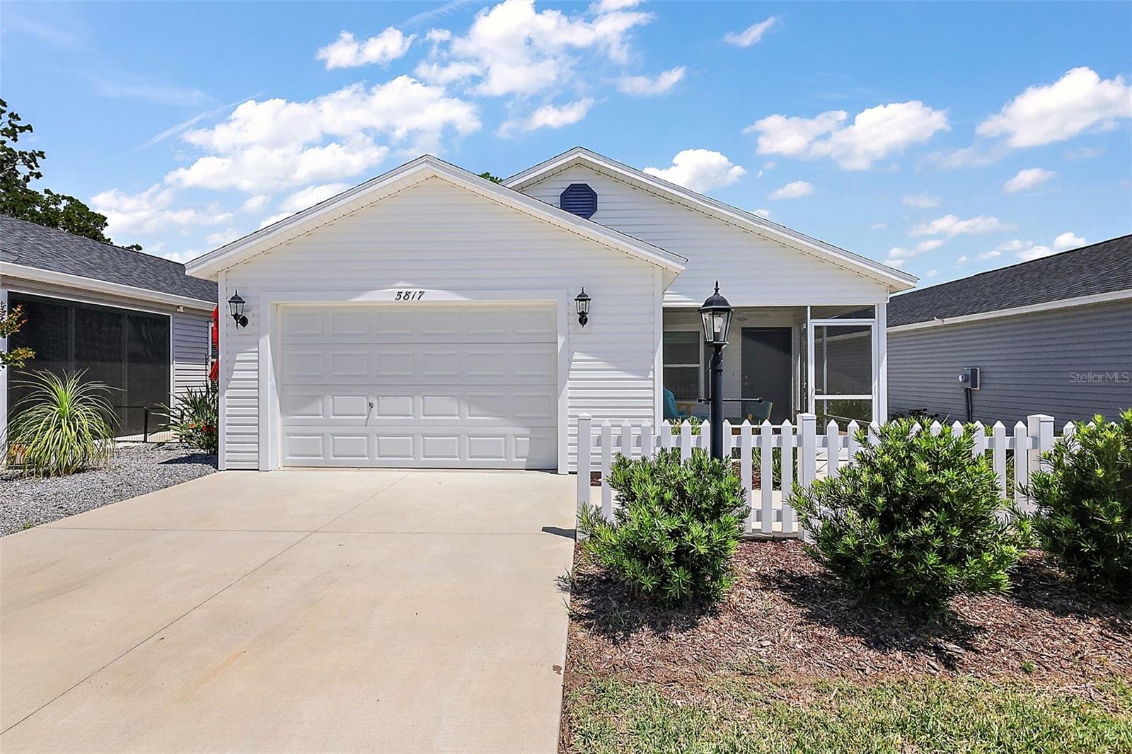 Stunning 2 Bedroom, 2 Bath Villa located on a quiet street in The Village of Hammock at Fenney just a short golf cart ride away from the Fenney Recreation Center, world class golf courses, pickleball courts, multiple pools, Fenney Grill, Magnolia Shopping Plaza, and miles of scenic nature trails. This move-in ready villa offers a peaceful retreat with no rear neighbors that allows you to enjoy all the Villages has to offer. Thoughtfully designed, this home features an open floor plan with high ceilings, recessed lighting, and luxury vinyl flooring. Along with spacious kitchen with tons of cabinet space, stainless steel appliances, a gas range, and a large island that provides additional countertop seating. The primary bedroom has a huge walk-in closet and looks out to the private back yard with a wooded backdrop. The primary bathroom includes an easily accessible walk-in shower. Relax year-round in the screened-in front patio with a ceiling fan or the private side patio, accessible through sliding glass doors in the living room. Additional features of this home include an oversized one-car garage with room for a golf cart, an energy-efficient tankless water heater, and attractive, low-maintenance landscaping. The Villages is well known for its endless activities, world-class golf courses, and top-quality daily entertainment. Call today to schedule a tour and experience the amazing benefits that The Villages residences enjoy every day!