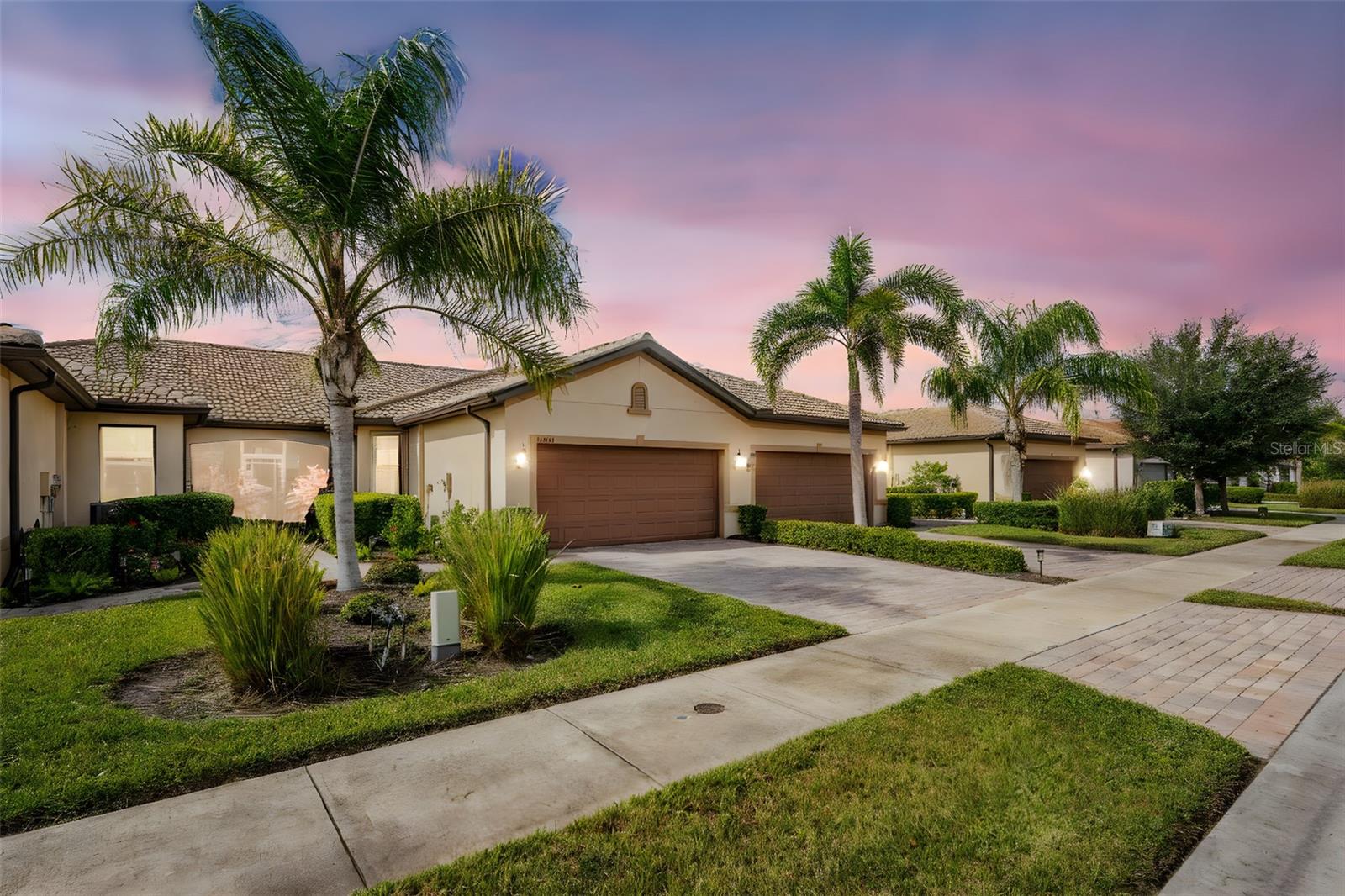 Welcome to this immaculately maintained Seagrove model with a beautiful LAKE VIEW, featuring 2 bedrooms, 2 baths, + den/office/guest room, and an attached 2-car garage! This maintenance-free villa, nestled within the gated community of ISLANDWALK, offers a unique chance to enjoy paradise in one of WELLEN PARK’S most desirable locations, with low HOA fees covering lawn care, cable, internet, resort-style amenities, 24-hour security, and situated in an X flood zone for peace of mind (no flood insurance required). As you enter through the screened front porch, you will find neutral tile flooring throughout and an open-concept layout perfect for both entertaining and everyday living. The split-bedroom design allows privacy for you and your guests, while the versatile den offers frosted glass double doors, providing privacy to use as a third guest room, home office, or quiet retreat. The primary suite enjoys peaceful lake views from two sunlit windows and includes a spacious walk-in closet and an en-suite bath with dual sinks, granite counters, and a walk-in tiled shower. The heart of the home features a spacious kitchen with crisp white cabinetry, sleek granite countertops, and a stylish subway-tile backsplash. A one-level peninsula with bar seating creates the perfect space for entertaining or casual dining. This kitchen also includes a custom built-in dry bar with additional cabinetry — a tailored upgrade that maximizes space and function, adds counter space, and transforms an otherwise empty wall into a functional storage and serving area. Upgrades include a black stainless appliance package (French door refrigerator, smooth-top range, built-in microwave, and dishwasher), complemented by abundant cabinet storage and recessed lighting.
The adjoining living and dining areas flow together, creating the perfect setting for gatherings or simply enjoying the peaceful setting. Step outside to your private lanai and take in tranquil water views — the perfect spot for morning coffee or evening sunsets. Additional highlights include an epoxy-finished garage floor, ceiling storage racks, a garage ceiling fan, and WHOLE HOUSE ACCORDION HURRICANE SHUTTERS for peace of mind. IslandWalk is one of Venice's most sought-after communities, offering miles of golf cart, walking, and biking trails over Venetian-style bridges. Residents enjoy an active lifestyle with amenities including a 24-hour staffed gate, full-time lifestyle director, event center, 2 CLUBHOUSES, 2 HEATED RESORT POOLS, a HEATED LAP POOL, 2 hot tubs, 2 FITNESS CENTERS, 12 PICKLEBALL courts, HAR TRU TENNIS courts, DOG PARK, playground, basketball, bocce, an outdoor pavilion with BBQ grills and fire pit, a library, and full-time HOA staff seven days a week. From the resident-only side entrance, you can access Downtown Wellen Park by car, golf cart, bike, or on foot. Nearby are the Atlanta Braves Stadium and the vibrant new downtown district, featuring an 80-acre lake with walking trails, shops, coffee spots, restaurants, a splash pad, fishing areas, kayak rentals, and a public town hall and park hosting concerts and a Farmers Market. The adjoining Marketplace offers Publix, restaurants, shops, banks, professional offices, a gas station, and a brand-new Costco minutes away. The community’s prime location places you just 4 miles from I-75, with pristine Gulf beaches, airports, Historic Venice Island, and year-round cultural events all within easy reach. Call today for your private showing!