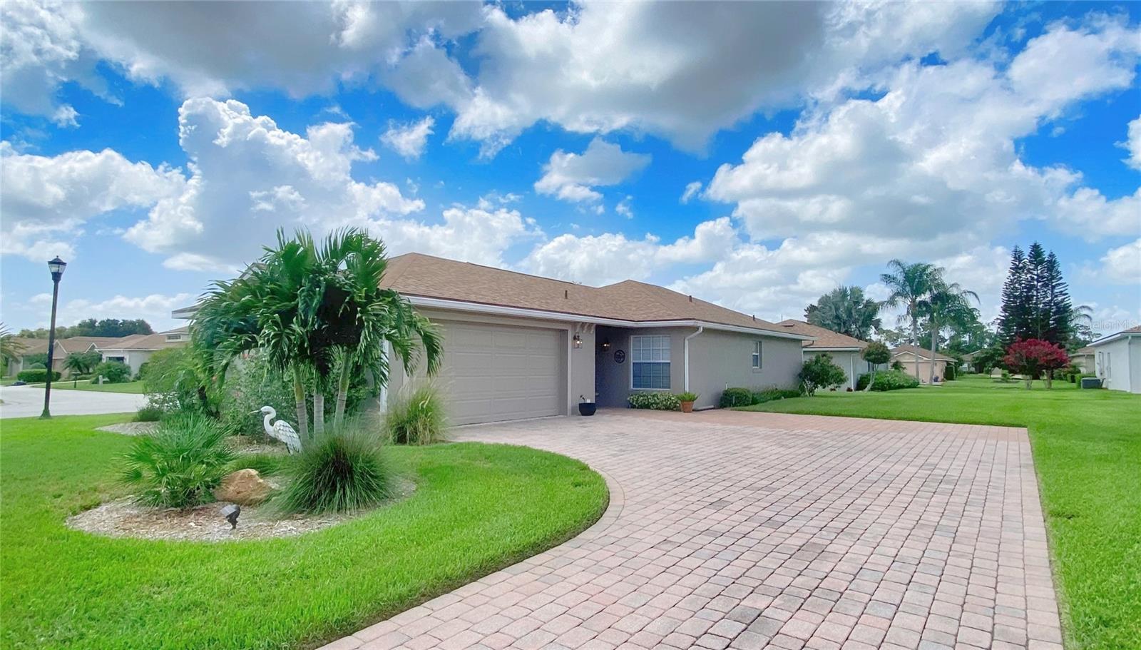 BEAUTIFULLY UPDATED HOME in the highly sought after community, Lake Ashton, a 55+ community with resort style amenities and activities. This is a 2 Bed/2 Bath home on an oversized corner lot with extended driveway and side entry garage. Offering comfort and style with over 1100 sq.ft. living space, this home with luxury vinyl flooring has an abundance of natural light in the living room, dinette and kitchen areas. The master suite has a walk in closet with organization system and the master bathroom has a new vanity with granite countertop, new hardware and the walk in shower is a bonus. The guest bed/bath area has a pocket door that offers privacy from the living room area. A murphy bed in the guest bedroom is the perfect space solution. The guest bathroom has been updated with a new vanity that includes pull out drawers, granite countertop, new hardware, new mirror and wall cabinet. The kitchen was updated in 2021 with 42"cabinets with molding, granite counter top, stainless steel appliances and tiled backsplash. You'll love the window above the sink and the pull out drawers and cabinet space in this kitchen. A spacious breakfast bar and ample counter top space is ideal for food prep and display. The screened, covered lanai is accessible from the living room with triple sliders that stack. For an added touch of class, crown molding is throughout this home. Additional updates to this home include: NEW ROOF (2022), INTERIOR PAINT (2021), LUXURY VINYL FLOORING (2021), NEW WINDOW COVERINGS (2021), BATH VANITIES AND HARDWARE FIXTURES (2022), NEW SCREEN ENCLOSURE( 2023), 20" OF INSULATION IN THE ATTIC (2023), SEPARATE IRRIGATION SYSTEM (2023), EXPANDED PAVERS IN THE DRIVEWAY (2022), MASTER CLOSET REMODEL (2022), NEW LIGHTS AND CEILING FANS (2021). AIR CONDITIONER (2018) AND HOTWATER HEATER (2019). Make your appointment today to tour this home. You'll be glad you did!
