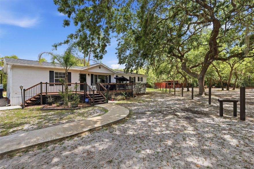 Welcome home to 41736 Apollo Lane. This private 2 acre property is fully fenced with additonal fencing for horses or other livestock. The main home is 3 bedrooms, 2 baths and nearly 1900 sq feet! Interior features include a split floor plan, office space, separate living rooms, a large primary bedroom and wood burning fireplace. NEW roof in 2024. Two sheds on the property for storage and a Rainsoft water purification system that conveys. Home is on well and septic. A perfect retreat close enough to major highways. Located on the Lake County side of DeLand. Pine Forest Park, the Seminole State Forest and a U Pick Blueberry farm are all close by. Property also features agricultural zoning, a 30 amp RV hookup, fire pit, two horse stalls and a pole barn; both with power and water. Feeding stations and additional fencing on the property. Private gated entrance with remote, solar lighting and mature landscaping make this a beautiful property.