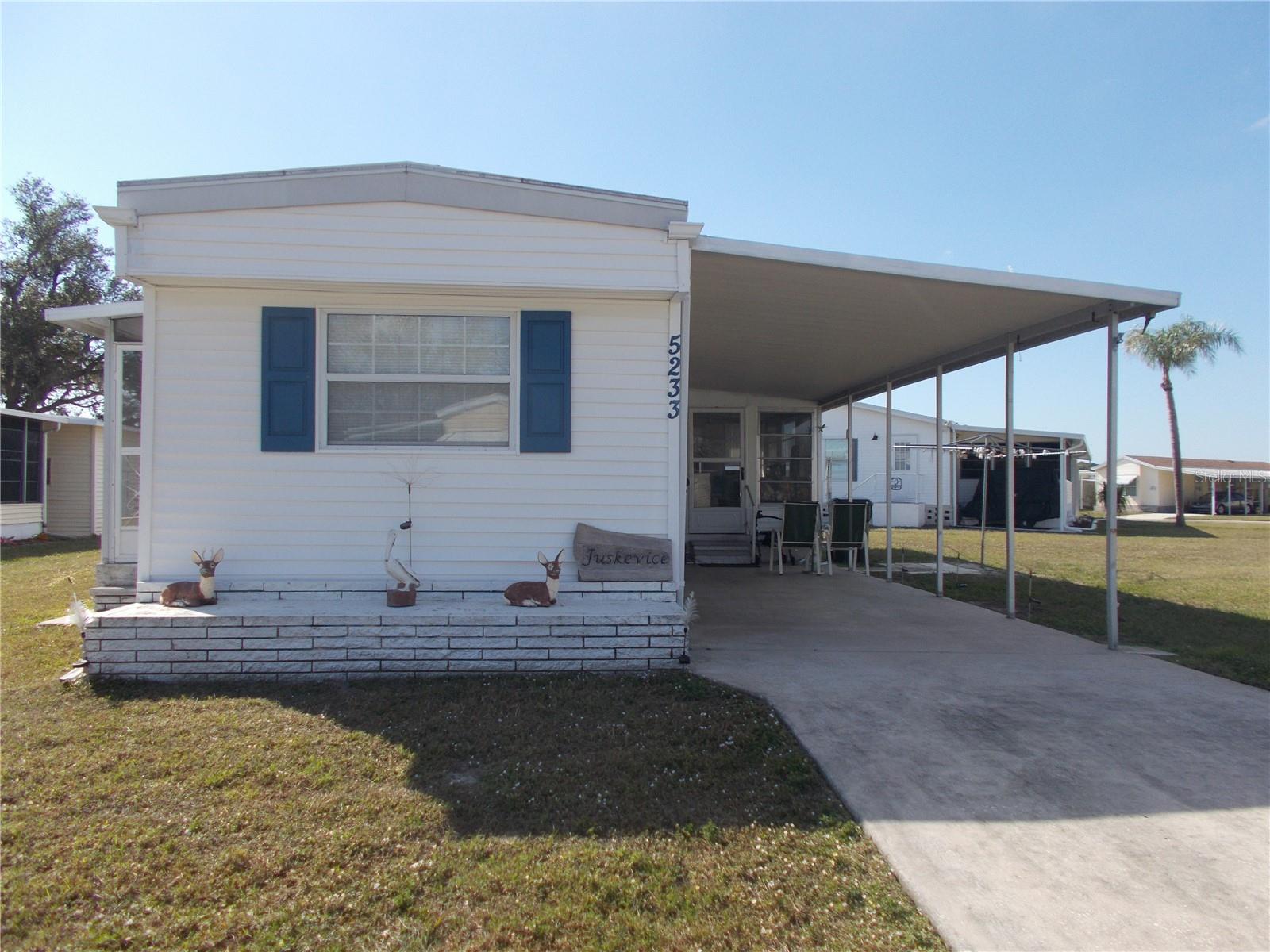 This is a 2 Bedroom, 1 Bath home, NOT IN THE PET SECTION, in the Gated Community of Holiday Park. You have a Double sink and a Gas Stove in the Kitchen and the Washer and Dryer are on the Lanai. You have a small storage closet on the Lanai and a 4 X 8 Shed in the back of the home. On the left side of the home is a 5 X 6 Porch. As per the owner the Roof 2014, AC 2018, Outside electrical Box 2021 and Propane 2018. Also this home has thermal pane windows in all rooms in the house except the Bathroom. In Holiday Park you own the land with a deed and your $195.00 monthly maintenance fee ($2340.00 a year) is included in your taxes. The community features 2 clubhouses, 2 swimming pools, a library, a fitness room, tennis courts, pickleball & bocce courts, to name a few. You are close to shopping, dining, entertainment, numerous golf courses, sports facilities, and SW Florida's renowned beaches. Come take a look!