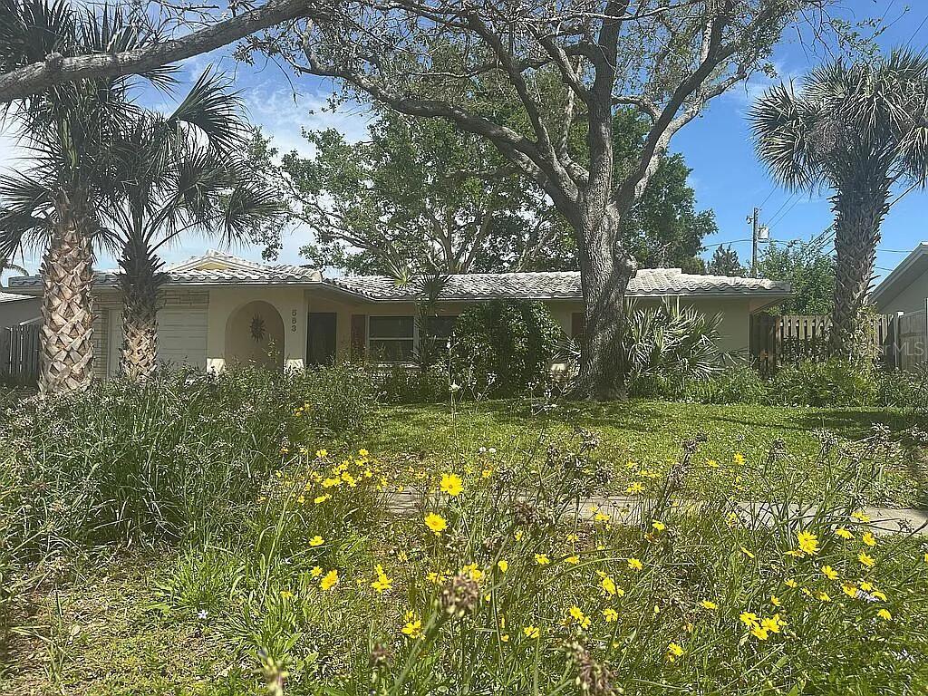 Elevated Waterfront Gem on Allen's Creek (Tampa Bay access). A Nature Lover's Dream - dock with room for 20+ ft boat and room for a pool! Tucked away on the tranquil brackish waters of Allen's Creek, this charming 2-bedroom, 1-bathroom home with an attached 1-car garage provides a unique blend of modern comfort and natural beauty. With approx 100 feet of waterfront where manatees and dolphins play, this property is a slice of paradise. The expansive lot is beautifully landscaped with mature trees front and back yard, FL native landscaping. It's great for outdoor activities such as fishing, boating, paddleboarding or kayaking and entertaining via the large screened in back porch. Inside, you'll find a renovated kitchen, Stainless-Steel Appliances, including a refrigerator, dishwasher, stove with a vented range hood, solid wood cabinets and granite countertops. The bright and airy dining room looks out to the open backyard patio. The spacious floor plan includes solid wood floors, tile with new lighting fixtures and ceiling fans. Two large bedrooms provide privacy and comfort. Recent upgrades include a whole house water filtration system, hurricane shutters, updated windows and ceiing sun window in bath. The expansive backyard features a patio for relaxing and entertaining, and a reclaimed sprinkler system to maintain the lush landscape. Located just over a mile away from Eagle Lake Park with its 162 acres of amenities, and under 2 miles from Largo Central Park with a community center and a library next door, this home provides convenient access to many activities. Enjoy nearby beaches like Belleair, Sand Key and Clearwater, explore the Clearwater Marine Aquarium and marina, as well as a quick route to the St Pete and Tampa International airports. With a variety of restaurants and spring training fields within easy reach, this home on Allen's Creek is a rare find. The major added bonus is how elevated the land is, so no worry about flooding while enjoying water living!