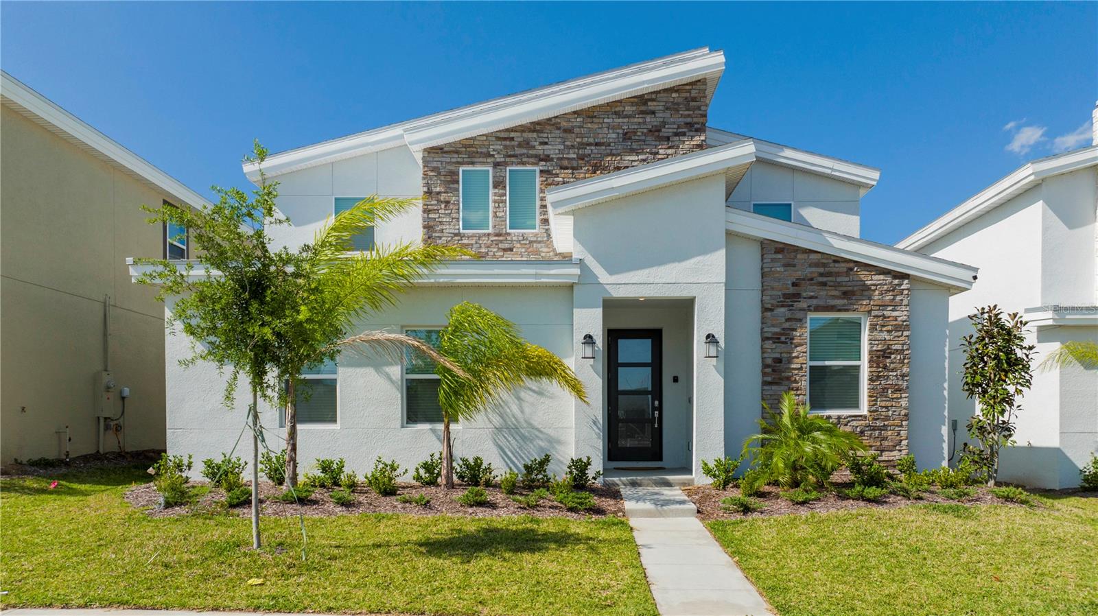 Welcome to 9312 Sommerset Hills Drive where you will discover this exceptional 8-bedroom and 5-bathroom vacation home that accommodates 22 guests in premium location boasting over 4,000 sq. ft. of luxurious living space in the beautiful, gated Champions Gate community. This fully furnished luxury property, built in 2021, offers an open-concept layout with a gourmet kitchen which is fully equipped with all the appliances you could think of and a high chair too! Elegant dining that seats for 12 and spacious living areas. The outdoor space welcomes you with a relaxing lanai overlooking the heated pool of 5 feet deep and a spa waiting for you to unwind at the end of your day.
The pool enclosure has privacy screens on both sides for ample privacy and there are no neighbors behind the home. Talk about location!! Just under a 6 minute drive from world-class amenities and a newly constructed clubhouse! This property is ideal for investors or as a serene home away from home. With themed bedrooms, versatile entertainment spaces, and access to resort-style clubhouses, golf courses, pools, and more, this home is designed for relaxation and fun. Conveniently located near shopping, dining, and Orlando’s top attractions, it’s a must-see opportunity. Just 10 miles from Disney and 22 miles from Universal Studios, sometimes, the wait is worth it! Schedule your private showing today to make it yours before its too late!!