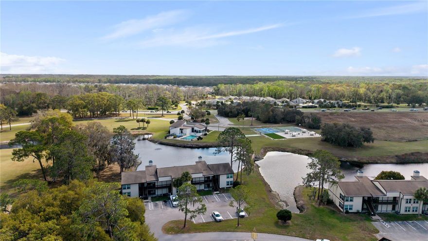 Just minutes from The Villages, this condo puts you close to one of Central Florida’s most sought-after lifestyle destinations—offering nightly live entertainment, dining, shopping, golf, and recreation. Inside, the home features a bright, open layout centered around a real wood-burning fireplace. The living and dining areas connect easily, creating a functional, well-designed space. The kitchen includes stainless steel appliances, generous cabinetry, and ample counter space.

Two well-sized bedrooms provide flexibility for guests, a home office, or additional use, along with an in-unit laundry area for added convenience.

A standout feature is the two separate entrances, offering the potential to create two private living spaces—each with its own bedroom and bathroom—making this a strong option for guests or income-producing potential.

Residents enjoy access to community amenities including a pool, pickleball courts, and scenic lakefront surroundings—all while being just a short drive from Sawgrass Grove and Brownwood Paddock Square.

Flexible layout, prime location, and close proximity to everything The Villages has to offer.