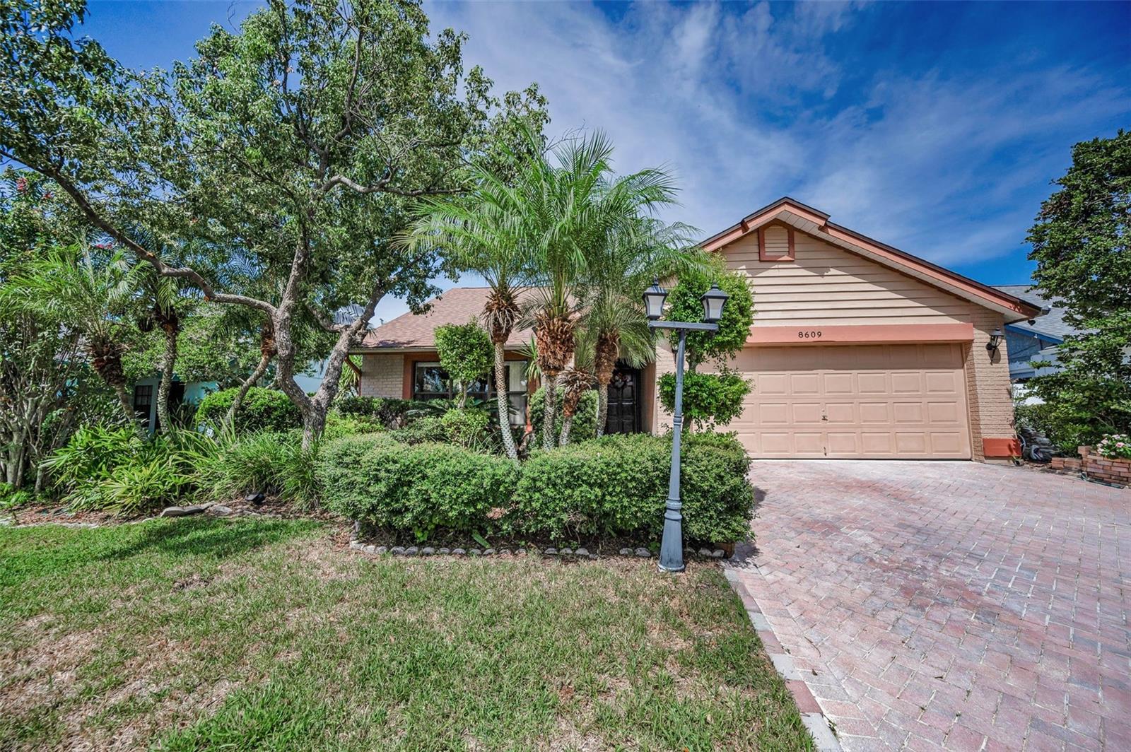 Check out this Wonderful Pool Home with a 3 Bedroom, split plan, and 2 Bathrooms, in DESIRABLE WESTCHASE/COUNTRYWAY AREA. HIGHLY-RATED SCHOOLS! NOT IN A FLOOD ZONE, NO CDD & LOW HOA fees. Located in the Meadows in Countryway, this spacious family home boasts an open floor plan and high ceilings with separate living room and dining room, plus a family room with a cozy wood burning fireplace. As you enter the home, you can see to the back of the home and the beautiful pool area. The family room is adjacent to the large kitchen which features granite countertops, a breakfast bar, stainless appliances, built-in wine rack, great cabinet space and an abundance of countertop space. The primary/master suite has a walk-in closet, private access to the pool area, and a totally updated en suite bathroom with new cabinetry, double sinks, granite countertops, walk-in shower with a bench and a glass enclosure. On the opposite side of the home, the other 2 bedrooms are generous in size and one bedroom has sliding glass door access to the pool area. The Main/Guest bathroom has been totally updated with new cabinetry, granite countertops and a tub/shower combination. Step out to the pool area using the sliding glass doors from the family room or the kitchen to the large screened swimming pool (with a child safety fence) and a great covered entertaining area with an outdoor kitchen. A tropical paradise with privacy, fenced and lush landscaping. The oversized 2 car garage has a electric door opener and a side service door. 2024 ROOF, A/C 2015 with transferrable service/warranties. Pool was resurfaced 3-4 years ago, Pool Pump 2 yrs old, new pool filter. TERRIFIC LOCATION – 5 min drive to Publix, Walgreens and Target, PetSmart, Walk to West Park Village Town Center with great shopping and restaurants, 20 mins. to Tampa Int’l Airport, nearby Pinellas County Beaches, Miles of scenic biking/running paths from this home! Countryway offers many amenities including a golf course, tennis courts, park, playground, plus more. Don't miss out on this tremendous opportunity to make this your new home!