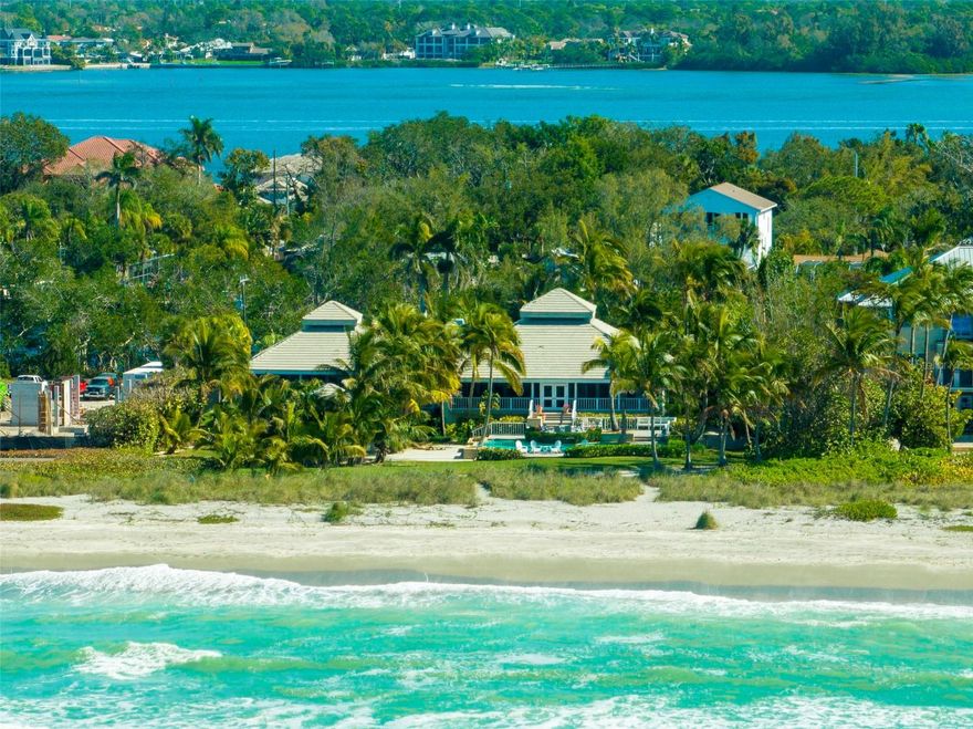 This is the only property on either Siesta, Lido or Longboat Key that fronts directly onto the walking sand. You can walk the entire stretch of beach right out your back door in the ultra-private and highly sought after Sanderling Club. In a close call for #1, HGTV viewers selected this spectacular beachfront property as their runner-up in the ultimate beachfront homes category. Presiding over sensational views of the Gulf of Mexico behind the private gates of the Sanderling Club, there are few equals when it comes to tranquility, privacy and the rarity of stepping directly onto the sand. Enveloped by magnificent tropical palms, the 1.3 acre site spreads 150 feet across the shoreline and encompasses a 2 or 3 bedroom principal residence and private 1 bedroom cottage, all extending along one of Siesta Key’s most glorious stretches of sand. With a distinctly Caribbean personality, a refresh of the interior spaces would transform this open design that brings a sense of calm and purpose to every day. The warm palette of cream, taupe and coastal woods, along with luminous skylights and French doors, are a natural fit for the dreamy beachfront setting. It’s easy to feel culinary inspiration in the graceful kitchen, featuring a practical island with Wolf cooktop, built-in GE double oven, Sub Zero refrigerator, walk-in pantry, and wine refrigerator. A great room with wood burning fireplace, formal dining room, study, second level loft and ground level living space provide a wealth of environments for everyday moments and entertaining. A restorative ocean view escape, the owner’s suite is superbly appointed. The island magic continues outdoors, where a wrap-around terrace, screened lanai and private pool deliver unparalleled beachfront spaces to enjoy alfresco living, day and night. Tremendous first level storage is a bonus. This home is charming and perfect for a remodel. Due to the fact that the majority of the list price is allocated to the land value, one may consider building a home commiserate with the other mega homes along the shoreline. A private dock on Heron Lagoon is the gateway to serene kayaking adventures through the mangroves. The Sanderling Club is privileged to feature a clubhouse and beach cabanas designed by one of the founding fathers of Sarasota Modern architecture movement. Boat docks are located on Bayside. While offering a sense of seclusion in a private gated enclave, this property is within easy reach of fine restaurants, organic markets, excellent health amenities, golf courses and more.