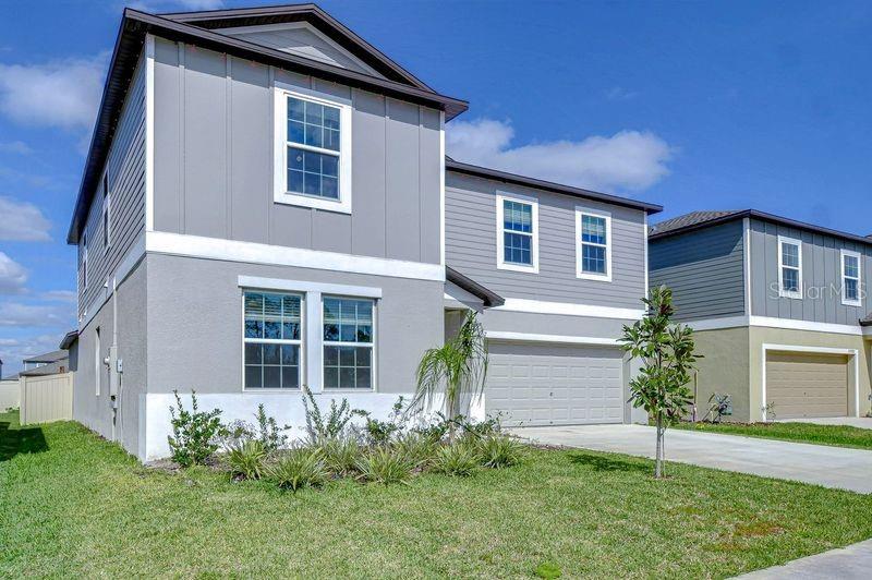 This modern home is a true gem! With 6 spacious bedrooms, 3 bathrooms, a flex room, and a loft, it offers so much space and versatility for any lifestyle. The moment you enter, you’re greeted by luxurious upgrades like the stunning accent wall and the sleek white tile flooring throughout the common areas. The guest room and bathroom are perfect for visitors or could double as an in-law suite. The open-concept kitchen, family room, and dining area create a warm and inviting atmosphere. The custom-built fireplace in the family room adds a touch of elegance with its cedar wood mantle and hearth. The upgraded kitchen features a beautiful, upgraded stone backsplash and wood cabinetry with crown molding. The large primary bedroom is conveniently located on the first floor, which has new luxury vinyl flooring. The primary bedroom has an en-suite bathroom and an impressive walk-in closet. Upstairs, you’ll find a spacious loft area that could be transformed into a game room, media center, or anything else you envision. Plus, four more bedrooms and a 3rd bathroom give plenty of space for family or guests. One bedroom is currently used as an office, making it ideal for remote work. Outside, the expansive backyard features a large custom deck that’s perfect for entertaining or relaxing. The front of the lot faces a cul-de-sac, offering a feeling of relaxing openness. HOA fee includes internet. The yard is fully fenced and has a custom floating deck. New charter school Pinecrest Academy is a pubic charter school is open and ready for. enrollment. Connerton is known for its amazing community amenities, including a clubhouse with a restaurant, gym, play center, and large pools with amazing water features. Connerton’s second clubhouse and amenity center is underway. Plus, you’ll have easy access to nearby restaurants, schools, shopping, and access to the Veterans Expressway. If you’re looking for a move-in-ready home with stunning upgrades and an unbeatable location, this is the place for you! Come see it for yourself, you’re going to fall in love!