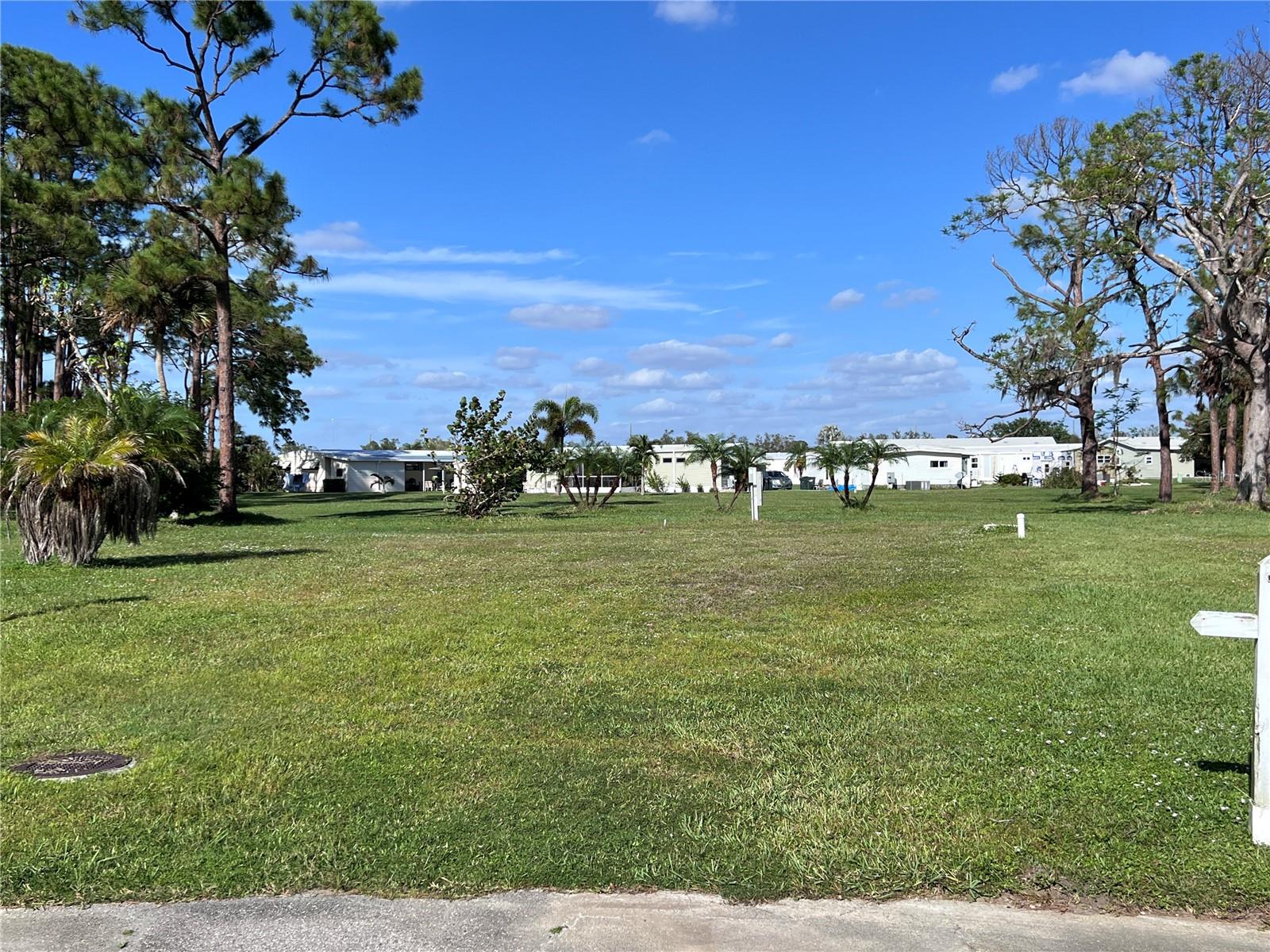 This oversized lot is waiting for you! Located on a cul de sac with greenbelt views. This lot is the perfect place to make your home and start living the Florida lifestyle you have been dreaming about. It is located in the 55+ gated community of Holiday Park and in the Pets Allowed Area. In Holiday Park you own your own land and the annual maintenance fee is included the County Property Tax Bill.Holiday Park is a VERY active community with a little something for everyone. Such as, 2 heated community pools, 3 tennis courts, 4 pickle ball courts, 3 bocce ball courts, 14 shuffleboard courts, 6 horseshoe pits, card room, library, fitness center, billiards, boat and RV parking, club house and an array of social activities. Holiday Park is conveniently located close to shopping, restaurants, area beaches and Cool Today Park. This is a fabulous opportunity to make this yours today!