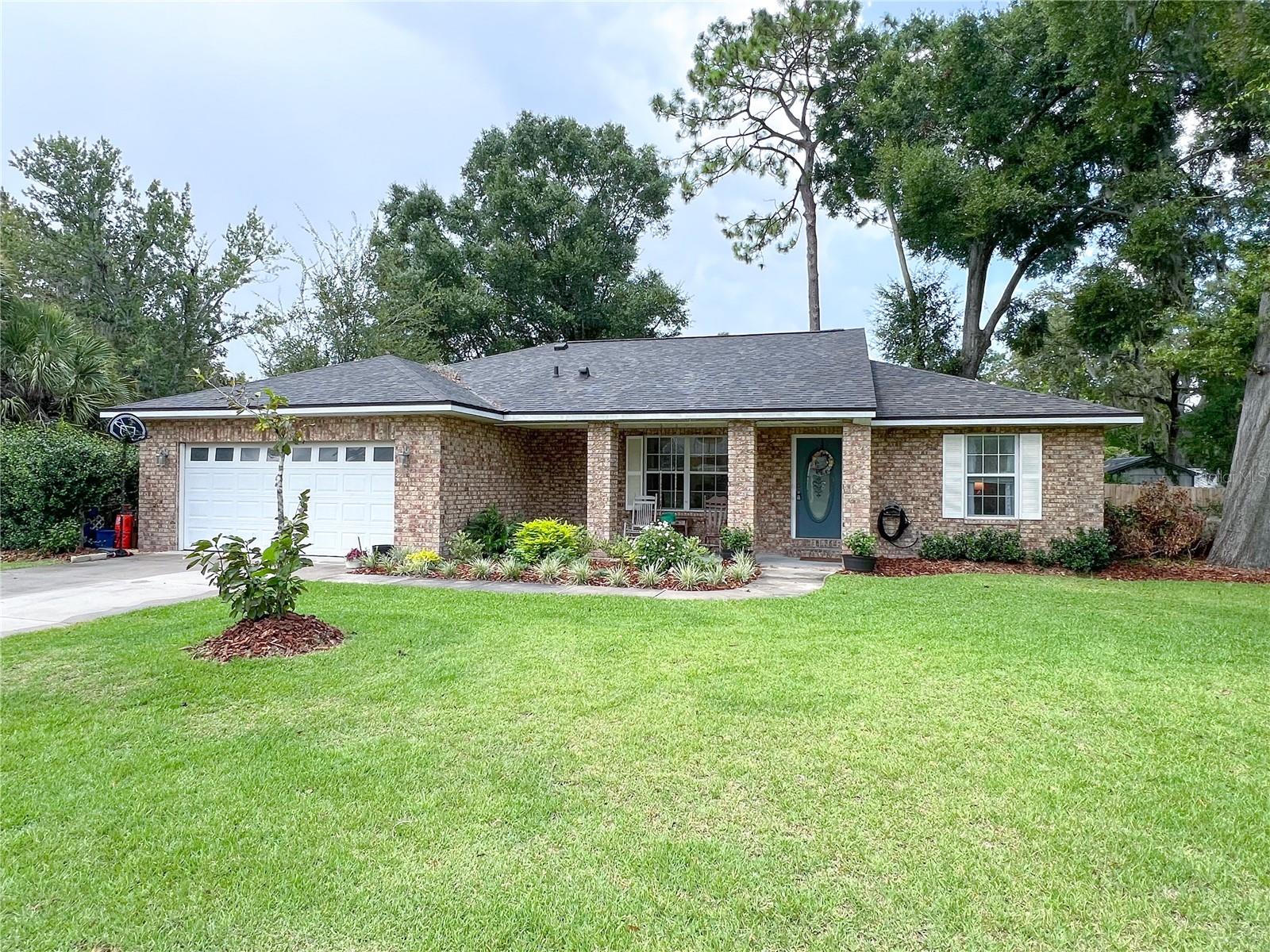 This charming 3-bedroom, 2-bath brick home offers a perfect blend of cozy and functional living with updated features throughout. Enjoy spacious living areas filled with natural light, a stylish kitchen with stainless steel appliances, and a split floor plan for added privacy. The primary suite offers a peaceful retreat with a walk-in closet and a private en-suite bath. Step outside to your own backyard paradise—complete with a covered patio, built-in grill station, and plenty of space for gardening, entertaining, or just relaxing under the shade of mature oaks. Additional features include a two-car garage and custom built-ins. With top-rated schools, local parks, and Newberry’s small-town charm just minutes away, this home is the total package! Grad students welcome! 2 pets welcome.