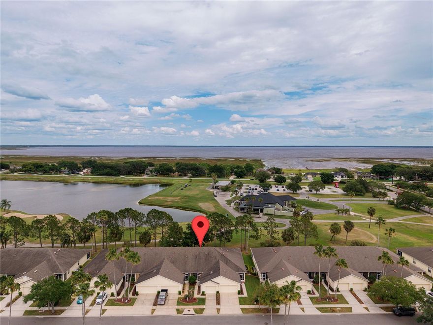 One or more photo(s) has been virtually staged. GATED, ON THE GOLF COURSE, BEAUTIFUL VIEWS, and it comes with a GARAGE!!!  BONUS: THE SELLER HAS PAID THE HOA DUES FOR ALL OF 2026!!  Both the FRONT & BACK PORCHES are covered & SCREENED......nearly 1400sf, it is a SUPER spacious 2-bedroom!!  Work from home??......this townhome also has a separate office!!  This room could be a den, a crafts area, or a 3rd bedroom with some minor additions. High ceilings, tile through-out (minus beds), ALL APPLIANCES STAY (even the washer & dryer), & the HOA REPLACED THE ROOF IN 2018. Our kitchen has a breakfast bar, closet pantry, & a welcoming bay-window dining. Sliders open to the back porch.....gorgeous view of Tee 1 & the Clubhouse. Leave them open for a dreamy breeze.......gorgeous Oaks provide that perfect shade, yard maintenance is handled by the HOA, the home's EXTERIOR IS ALSO COVERED BY THE HOA, & these townhomes have their own PRIVATE POOL. Gated for extra security, sidewalks for evening strolls, & access to the main Remington amenities are included. Centrally located between Kissimmee & St. Cloud, great proximity to the Orlando Airport, East Lake Toho & its lakefront beach can be reached within 4+/- miles.......looking to add to your portfolio??  This property would make an ideal investment......lease for a return!!  Wanting an affordable snowbird abode with little upkeep & FANTASTIC golf course accessibility??........this is it!!!  Welcome to the Remington Club Villas!!