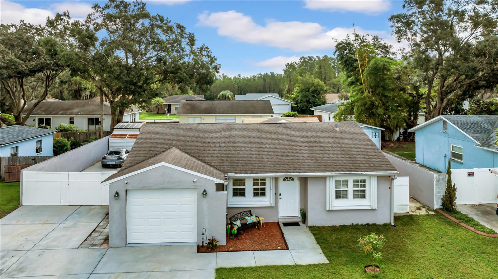 One or more photo(s) has been virtually staged. Storm-ready and built for both comfort and convenience, this extraordinary 3-bedroom, 2-bath Lutz home is a true fortress with block walls filled with cement, hurricane shutters on every window, and a fully fenced yard offering peace of mind year-round. Inside, you’ll find a spacious layout with an oversized kitchen featuring abundant cabinetry and a double oven, a master suite with a nearly 20-foot closet, and upgrades including a Jacuzzi tub, walk-in shower, tankless water heater, and Culligan water softener. Step outside to a backyard designed for versatility with two storage sheds, a large climate-controlled trailer with air and electricity, and gated parking with RV hookups for two or ample space for extra cars, toys, or projects. With keyless entry on every door, and French doors leading to your private retreat, this property is as functional as it is secure. Conveniently located near shopping, dining, I-75, and Tampa attractions, this one-of-a-kind home is perfect for anyone seeking a private, secure, and project-ready lifestyle.