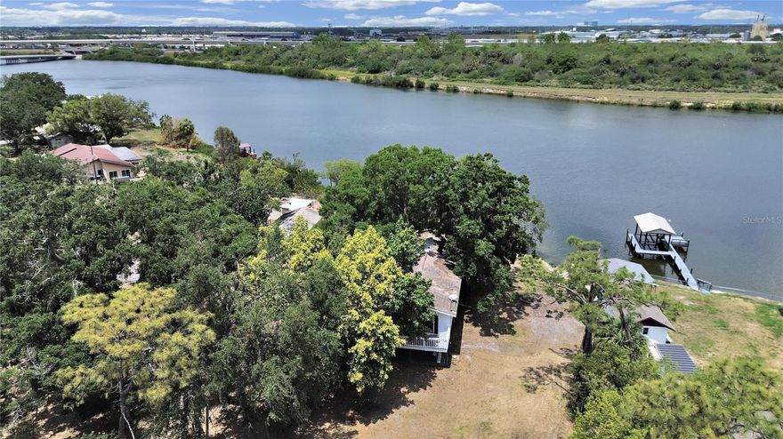 This unique Tampa waterfront property offers 485 feet of water frontage on the Palm River with direct access to McKay Bay and Tampa Bay. Situated on over 1.5 acres, the property includes a stilt home and accessory dwelling, with the true value in the land. Build your dream home and save on impact fees with utilities already in place, including well, septic, and electric service. Enjoy saltwater fishing right from your own backyard. The property features a fully fenced perimeter with gated entry, located on a dead-end street for privacy. Conveniently close to shopping, major roadways, and just minutes to downtown Tampa — with no HOA.