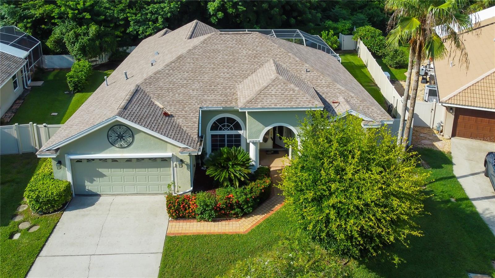 NEW ROOF SUMMER 2025! Nestled on just under 1/4 acre in the heart of Palm Harbor, this executive retreat has it all. Spacious bedrooms, well appointed bathrooms, high ceilings, gourmet kitchen, wood floor entryway, separate formal and informal spaces, new baseboards, a covered and screened lanai with brick pavers and a pool with spa spillover. Located in a quiet neighborhood and situated on a lot with complete rear privacy! Did we mention a new roof? Make an appointment today.