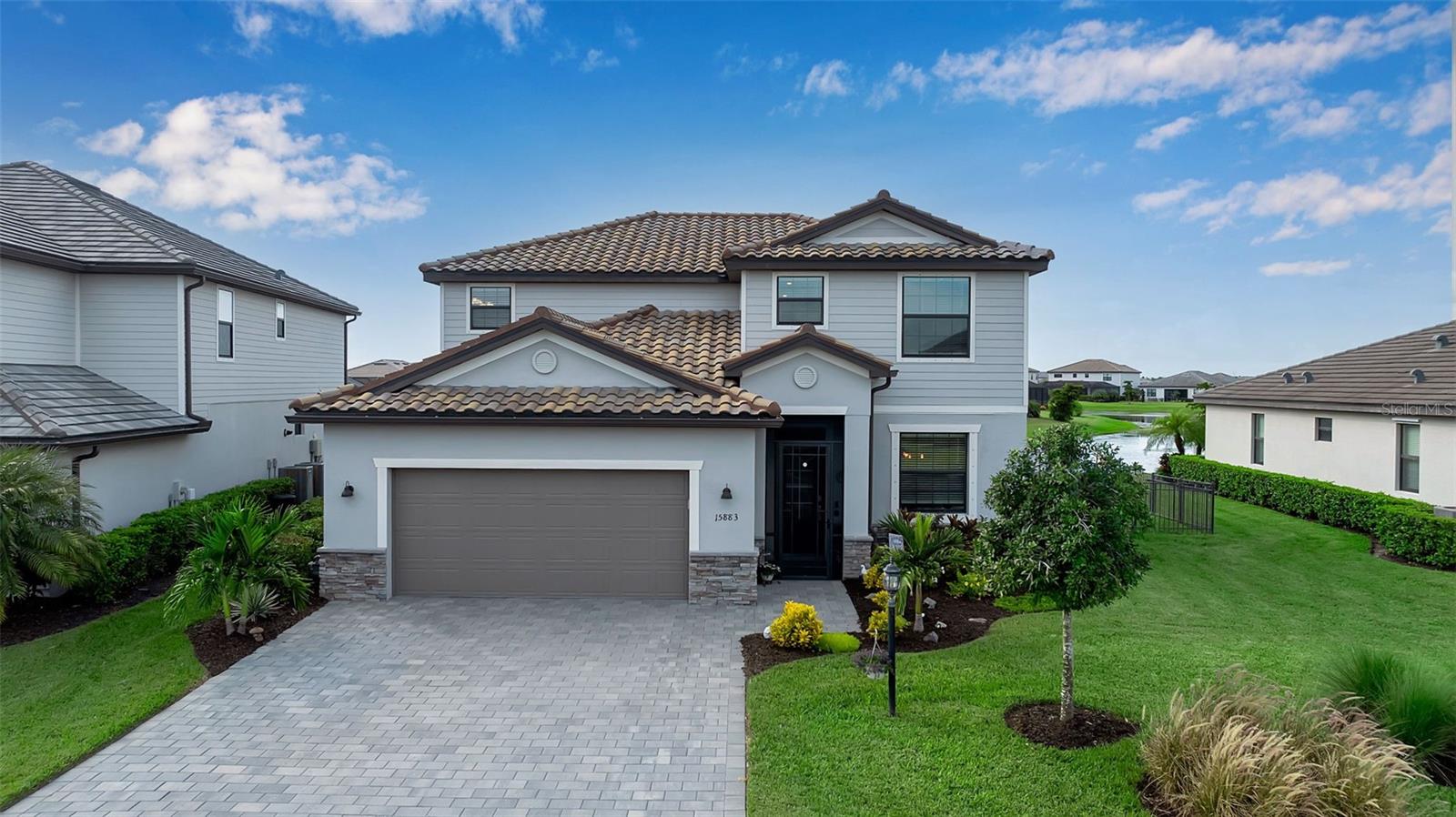 Welcome to your Florida dream home, in Lorraine Lakes at Lakewood Ranch, the #1 master planned community in the country! SELLER is contributing $10,000 towards closing costs with a signed contract by August 29th! Schedule your appointment today! From the moment you walk through the screened front porch, this beautiful lakefront pool home will enchant you with its 4 bedrooms, 3 baths, a bonus room, as well as 2,546 square feet of gracious living space. This home is also in walking distance to the Amenity center! Once inside, you’ll love the open floor plan with the spacious kitchen with natural gas, and a huge dolomite island with seating for all your guests. Stainless steel appliances, including a gas range, soft-close cabinetry, large farm sink, and crown molding on the cabinets, a Custom backsplash of “Fantasy Brown” dolomite up to the cabinets with a Large custom wall pantry. In the gathering room, the large sliding glass doors allow easy access to your covered “No See-Um” screened in lanai with your heated pool and spa, ideal for relaxing and entertaining while sitting under the Sunbrella retractable awning looking at peaceful views of the lake for that easy indoor/outdoor lifestyle we love here in Florida. Living in Lorraine Lakes means enjoying a vibrant, active lifestyle with 24/7 guard-gated security, internet and cable are included with your HOA fees and it is a maintenance-free community, so get rid of that lawn mower! You will enjoy some of the most extensive amenities in the surrounding area, like a clubhouse with 2 bars and indoor and outdoor dining, fitness center, indoor sports courts, resort pool, lap pool, splash pad, Bocce ball court, plus pickleball, tennis, basketball, sauna, a playground and trails surrounded by stunning lakes. Don’t forget about the dock overlooking the lake to throw your pole in but don’t forget its catch and release! When you want to venture out on the town, a short drive away are options. Lakewood Ranch downtown Main Street and Waterside are minutes away for shops, dining, live music, polo and international events. Then just a bit further to Sarasota and St. Armands Circle for the finest dining and shopping. Our beautiful beaches are also just a short drive away.