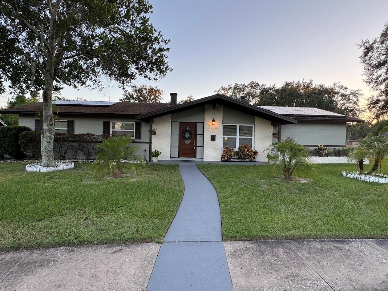 Prepare to be impressed with this lovely home in West Orlando. It's one of the nicest in the community and is nestled on a huge corner lot with mature landscaping. Inside the home you'll find a beautiful modern kitchen with granite countertops, newer stainless steel appliances and a Samsung 4-Door Flex French Door Refrigerator. In the kitchen there's also a stand alone island and wooden cabinets throughout. The home also has a dining room, a living room and a formal living room. With three bedrooms and two full bathrooms, there's plenty of room to relax.
On the outside of the home you'll find an eight year old roof with owner owned solar panels that reduce the energy bill to less than fifty five dollars a month. There's also a three year old A/C unit, a six year old water heater and lighting around the perimeter of the home. With a large fenced back yard with a guava tree and a covered patio and sitting area, there's plenty of room to entertain family and friends.