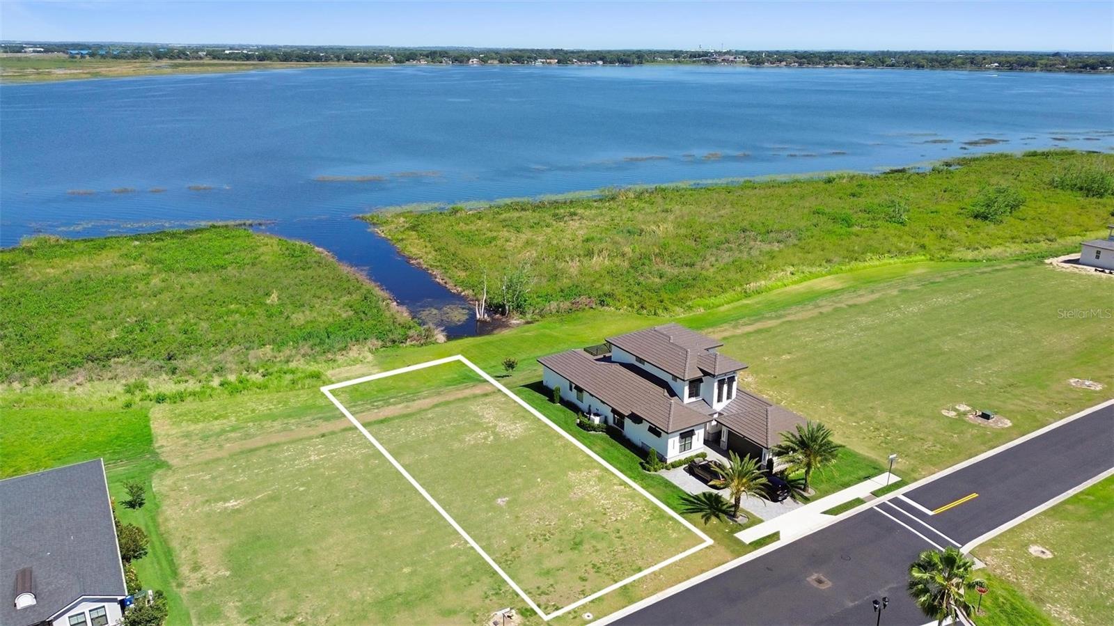 Embrace the opportunity to own this cleared, leveled vacant lot with an open view of beautiful Lake Alfred, offering extra privacy and endless potential—no time restrictions to build! Located in the upscale Water Ridge community, enjoy resort-style living with top-notch amenities including 3 pools, 2 boat ramps, pickleball and tennis courts, basketball, a state-of-the-art fitness center with sauna and lockers, fishing piers, plus boat and jet ski storage. Just 40 minutes from Disney and 25 minutes from Legoland, this lot is perfectly positioned in a rapidly growing area full of exciting new developments. Don’t miss your chance to build your dream lifestyle in a truly exceptional setting!Southeastern University in Lakeland (26 Min) Polk State College in Winter Haven (18 Min),40 min away from Lakeland Linder International
https://www.waterridge.com/lifestyle