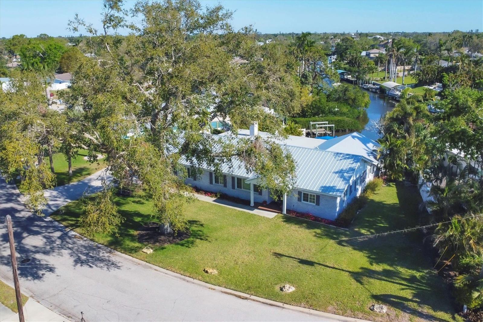 “Live where others vacation!” Waterfront home in Northwest Bradenton located on the saltwater canal of Warner’s West/Belair Bayou awaits its new homeowner where your memories can be made. Just under 3,000 sq. ft. of ample living space, this five-bedroom and three-bath pool home has a tremendous family room made for entertaining, built in bookcases on either side of the brick wood-burning fireplace, a combination formal living and dining room, an inviting kitchen boasts an abundance of wood cabinetry, large closet pantry, double ovens and expansive counter space. Step outside from the family room to your private outdoor oasis, featuring a saltwater pool with Pebble-tec surface, walk-in deck, a jetted seating area, and the generous sized paver patio area is the perfect space for outdoor entertaining or simply relaxing in the Florida sunshine. Boating enthusiasts will appreciate the convenience of launching their own boat directly from their backyard, offering easy access to the beautiful waters of Manatee River or Tampa Bay for a day of fishing, watersport activities or just a relaxing day on the water. Feel secure from hurricanes or flooding with 17’ elevation, concrete block, covered with real brick, 2018 installed metal roof and impact resistant windows and sliding door. No HOA, no deed restrictions, and no flood insurance required. (no flooding from recent hurricanes) This is a very livable floor plan in a great location that is less than five miles from the fabulous, pristine Gulf Coast beaches of Anna Maria Island. Schedule a private tour and see for yourself the unmatched charm this home offers.