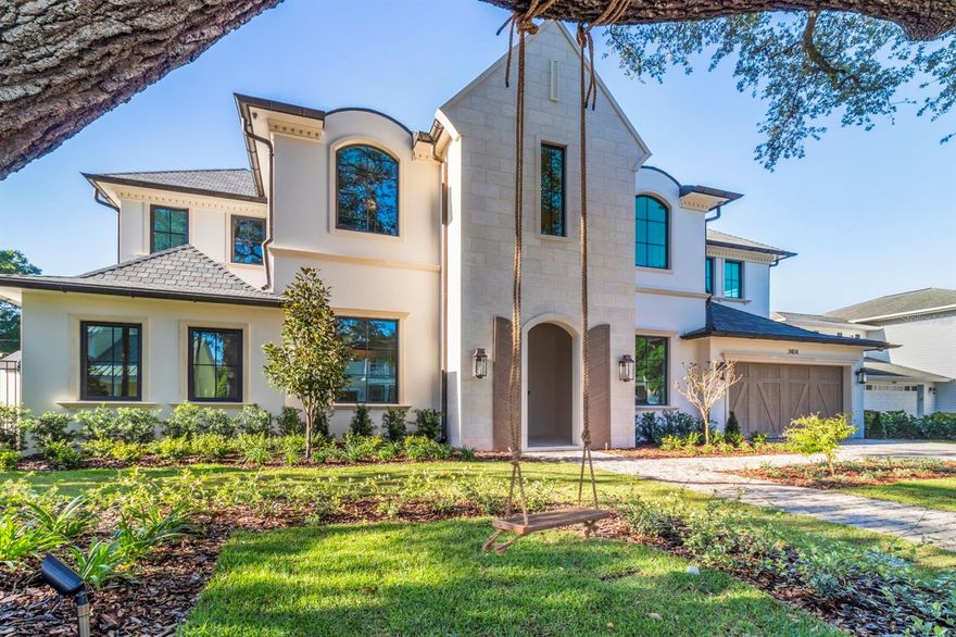 Welcome to this exquisite 5-bedroom, 5 full bath, 2 half bath residence offering over 5,400 square feet of luxury living space. Nestled in one of South Tampa's most sought-after neighborhoods, this custom-built home blends refined craftsmanship with modern convenience.

Step inside and be greeted by soaring ceilings, custom paneling throughout the grand foyer, and a dramatic curved staircase beneath a sparkling chandelier. Wide-plank hardwood floors flow into the open-concept living area, anchored by a gourmet chef's kitchen featuring custom cabinetry, high-end appliances, and an oversized island. A glass-enclosed 400-bottle, temperature-controlled wine room adds a sophisticated centerpiece for entertaining.

The wood-paneled club room is a showstopper, featuring a full bar and a state-of-the-art Full Swing Pro Series Golf Simulator. This premier simulator offers industry-leading ball flight and club path tracking technology, premium widescreen enclosure, laser projection, and an immersive selection of championship courses. Beyond golf, it also includes multisport and laser shot gaming packages, providing year-round entertainment for family and guests.

Retreat to the primary suite, complete with a spa-inspired bath featuring a freestanding soaking tub, dual vanities, and an oversized walk-in shower. A boutique-style custom closet with built-in cabinetry and a center island ensures both beauty and function. For added convenience, a stackable washer and dryer is also tucked into the master closet in addition to the home's main laundry room.

Outdoors, enjoy Florida living at its finest with a private pool, separate pool bath, covered lanai, and outdoor kitchen.

A backyard putting green adds to the resort-style experience, while a two-car garage provides ample parking and storage.

Additional highlights include multiple living spaces, ensuite baths in every bedroom, and a fully functioning back kitchen with refrigerator, sink, and dishwasher. Prime location minutes from Tampa's finest dining, shopping, and A-rated schools.