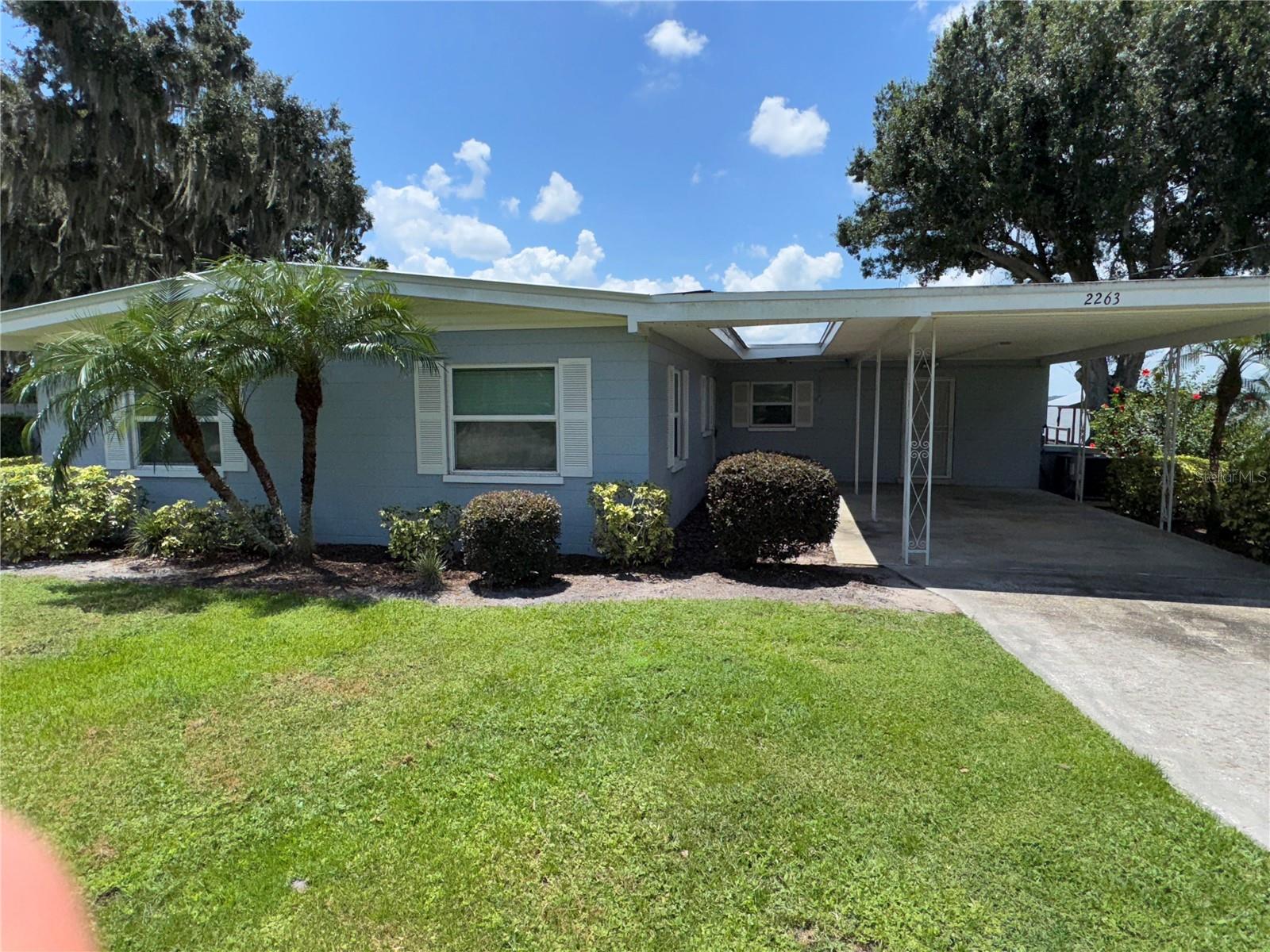 Lake Reedy Waterfront Home-Completely Updated 3-bed, 2-bath & Move-in Ready! Discover the perfect lakeside retreat in this beautifully remodeled Lake Reedy home! Originally built in 1960, this home has been completely redone while maintaining its vintage charm. Updated flooring with wood laminate in the living areas, ceramic tile in the bathrooms, kitchen has been updated with granite countertops and built in pantry cabinet, lots of storage closets. Spacious screened lanai with newer screens & a durable concrete floor- perfect for relaxing & entertaining. Single-car carport for convenient covered parking. Aluminum seawall to protect your shoreline. Private dock & covered boat storage, perfect for fishing, boating & enjoying the lake lifestyle. Nestled among a few majestic oak trees, this property offers breathtaking and peaceful lake views. This home is perfect for full-time living, a weekend getaway, or a vacation rental opportunity! Call today to schedule your private showing!