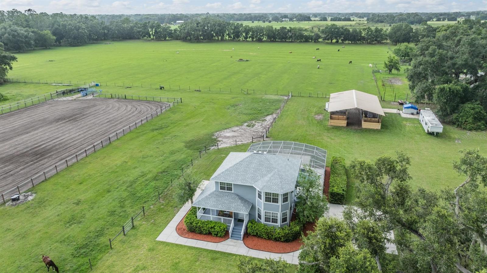 Set on a perfect square 9.6 acres, this property isn’t just built for living—it’s built for living the life. Whether you’re chasing sunsets or chasing steers, this ranch is rodeo-ready with its very own arena, designed for roping events but easily adaptable for daily training, barrel racing, or even conversion to an English setup with ease. It’s the kind of property that’s equally perfect for entertaining, relaxing with friends, or generating income by hosting local equestrian events—just as it has in the past.
The charming 3-bedroom, 2.5-bath home offers just under 1,800 living square feet and has been thoughtfully updated with a new roof, AC system, pool pump, fresh exterior paint, new flooring downstairs, and beautifully remodeled kitchen and bathrooms. Step out to the sparkling pool and take in the view of your horses relaxing peacefully in the barn, or sip your morning coffee from the front porch overlooking your grand improved pastures and iconic grandfather oaks.
The center aisle barn currently offers two stalls with space for eight more, and the property is fully fenced with cross-fenced pastures ideal for rotational grazing. With two RV hookups (one 50-amp and one 30-amp) and two separate septic systems, this ranch is perfectly set up to host visiting friends—or even generate income by welcoming northern equestrians looking to winter in sunny Florida.
This ranch checks all the boxes for those seeking the true Florida equestrian lifestyle—authentic, functional, and full of soul.