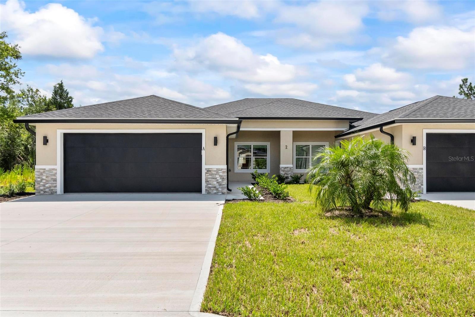 Be the first to live in this stunning new construction duplex located in Matanzas Woods, a desirable area of Palm Coast. This modern 3-bedroom, 2-bath home offers stylish design, quality finishes, and energy-efficient features throughout. Step inside to an open-concept living area with high ceilings, luxury vinyl plank flooring, electric fireplace and abundant natural light. Dining area and entry have feature walls. The gourmet kitchen boasts granite countertops, stainless steel appliances, shaker cabinets, farmhouse sink, tile backsplash and French doors to the covered lanai. The split-bedroom floor plan offers privacy, with a spacious primary suite featuring a walk-in closet and a sleek en-suite bathroom. Two additional bedrooms and a full guest bath provide comfort and flexibility for families or home office needs. Enjoy the outdoors on your private covered patio, overlooking a peaceful backyard. Additional features include an attached 2 car garage, laundry hookups, and a private driveway. Conveniently located near shopping, schools, parks, and just a short drive to the beach this home has it all!