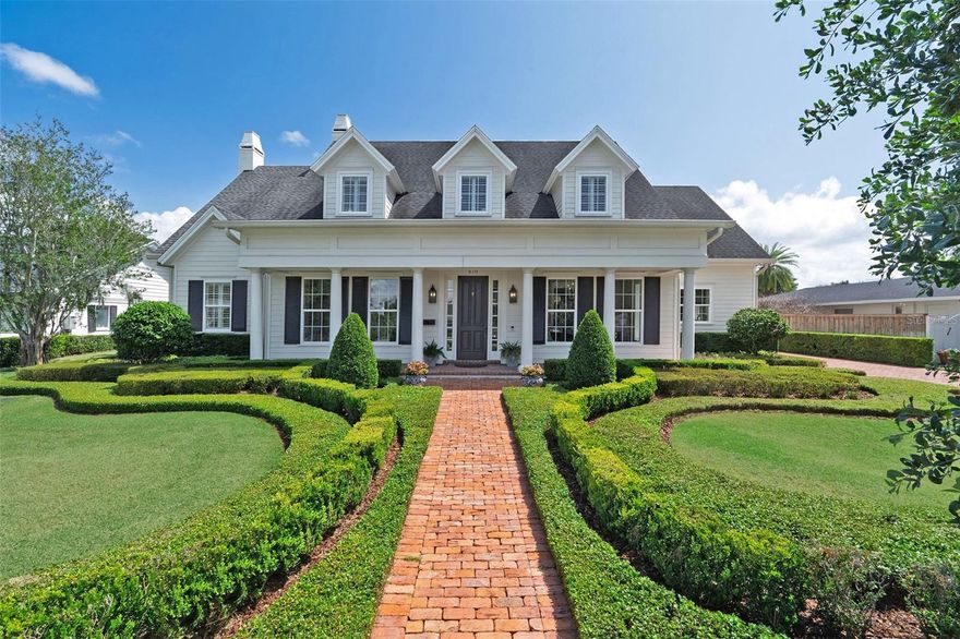 Graceful and timeless, this classic Southern-inspired residence by esteemed builder Charles Clayton sits on a generous lot in Winter Park’s coveted Park Grove neighborhood and makes a striking first impression with beautifully composed architecture, charming dormer windows, a sweeping front porch with historic reclaimed Detroit brick flooring, and curated landscaping. Inside, the foyer unfolds with rich wood floors, raised-panel wainscoting, layered crown molding and detailed millwork which sets the tone for depth and quiet sophistication throughout the home. Just off the entry, a beautifully appointed office with finely crafted built-in shelving thoughtfully designed for both display and function. The same refined trim details carry through, while generous windows introduce soft natural light—an ideal setting for work or a quiet reading. Across, the dining room is both elegant and inviting—bathed in natural light from large windows and enhanced by more detailed millwork that adds character and creates a polished backdrop for dining and entertaining. Continue through wide detailed trim opening to an expansive great room anchored by a classic fireplace with custom built-ins, while a wall of French doors invites in natural light and extends the living space seamlessly to the covered verandah with more reclaimed Detroit brick flooring and the pool, creating perfect space to gather, lounge or entertain. Open to the Great room, the beautifully designed kitchen stands out with a coffered ceiling, marble countertops, and crisp white cabinetry, featuring illuminated upper cabinets and open shelving for thoughtful displays. A central island is complimented by an integrated breakfast table—perfect for casual dining or morning coffee. Professional-grade appliances, including a Wolf gas range and Sub-Zero refrigerator, are paired with a thoughtfully tucked-away walk-in pantry offering abundant storage and effortless organization—bringing both refined style and everyday function to the kitchen. Positioned between the kitchen and living area, this adaptable space creates a natural gathering point—ideal for casual dining, relaxed conversation, or a cozy sitting area thoughtfully suited to your lifestyle. The 1st floor primary suite offers a true retreat, with an elegant, coffered ceiling, private verandah access and dual walk-in closets. The marble bath includes a generous glass-enclosed shower with double shower heads, pedestal soaking tub, a pair of vanities, and water closet. Completing the 1st floor is a large mud room with custom built-in bench seating and integrated storage, an oversized laundry room that blends utility and style with generous storage and marble counters, and a well-appointed guest bath accented with herringbone wainscoting. Upstairs, a versatile loft area is laid out to easily accommodate multiple uses—lounge area, work-from-home space, or media retreat. The 2nd floor split-bedroom plan features a separate guest suite, with vaulted tongue & groove ceilings,  a private living area and en-suite bath, a 3rd bedroom with an en-suite bath and walk-in closet, and two additional bedrooms are connected by a bath, plus an air-conditioned storage room. Outdoor living is elevated, with a covered veranda and built-in gas grill, overlooking a sleek, resort-style pool, marble decking, and a beautifully landscaped backyard. Every element of this home reflects livable elegance, all just a stone’s throw from renowned downtown Park Avenue.