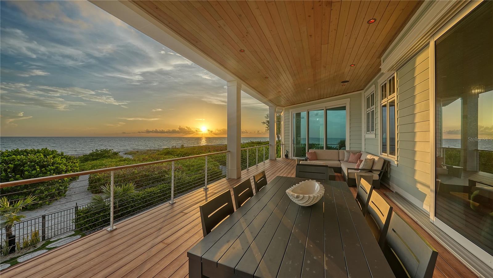 Unveiling the pinnacle of coastal living at this pristine beachfront residence at Bonaire Longboat Key. A newer gem completed in 2020, this luxurious home, offered turnkey furnished, is a rare find that invites you to immediately immerse yourself in the lap of waterfront luxury. The bliss of waking up to the Gulf's gentle waves is just the beginning of what this remarkable retreat has to offer. Crafted with precision and built by Eason Home Builders, this home seamlessly blends modern innovation with the allure of West Indies-inspired architecture. The result is a masterpiece that stands as a testament to lavish living on the Gulf of Mexico. Every corner of this residence is designed to capture the breathtaking beach views that stretch to the horizon. From the towering great room windows to the inviting balconies on each floor, the Gulf's beauty is your constant companion. Step into an interior that's not just beautiful but also brilliantly functional. Designer furnishings, smart home conveniences, and striking light fixtures harmonize with oak wood flooring and sleek surfaces, creating an ambiance that's as modern as it is inviting. The heart of this home is a chef's dream come true. The gourmet kitchen is a symphony of elegance and functionality, boasting custom cabinetry, a sprawling island, and top-of-the-line appliances. The CornuFe polished white and stainless-steel trimmed gas stove, accompanied by a statement-piece range hood, add to the allure of this culinary haven. The master suite is a sanctuary of indulgence. Set in a secluded northwest spot, it offers a private sitting area framed by bay windows, his and her walk-in closets, and a spa-inspired en-suite bathroom. This residence embraces the outdoors as an integral part of its charm. Balconies on each floor offer panoramic views and create a seamless indoor-outdoor flow. Recent updates enhance the allure of this home. A/V upgrades, solar shades, water softener, reverse osmosis, water chiller, and water pressure booster are just the beginning. The indoor cabana opens to a resort-style pool deck, complete with covered dining, a summer kitchen, lounge areas, a fire pit, and a saltwater pool with a swim bar and raised spa. Beyond the pool, your own gated access leads you to the pristine shores of the Gulf. The meticulously landscaped yard features a hammock, and convenient outdoor shower. This home also includes an additional parcel (the current owners have transformed this area into a botanical garden with beautiful lush landscaping). All that's missing in this turnkey masterpiece is you. With your personal belongings, you can step right into the lap of luxury and start savoring every moment.